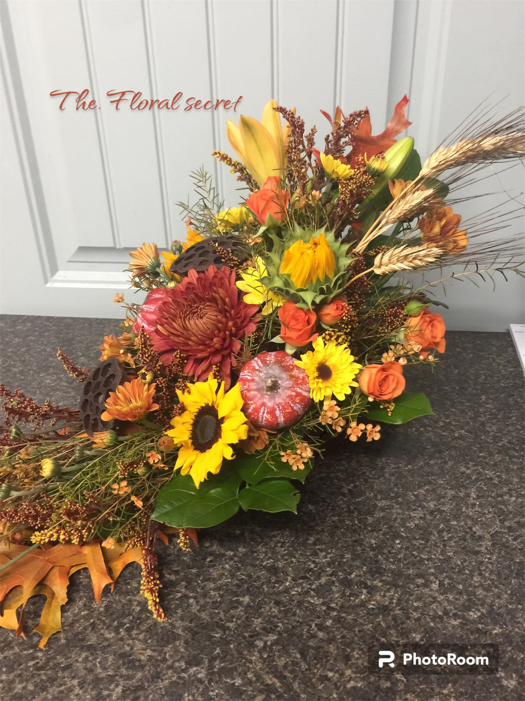 Autumn Harvest - cornucopia  filled with assorted fall flowers accented wtih pumpkins and pods. Perfect for any fall occasion