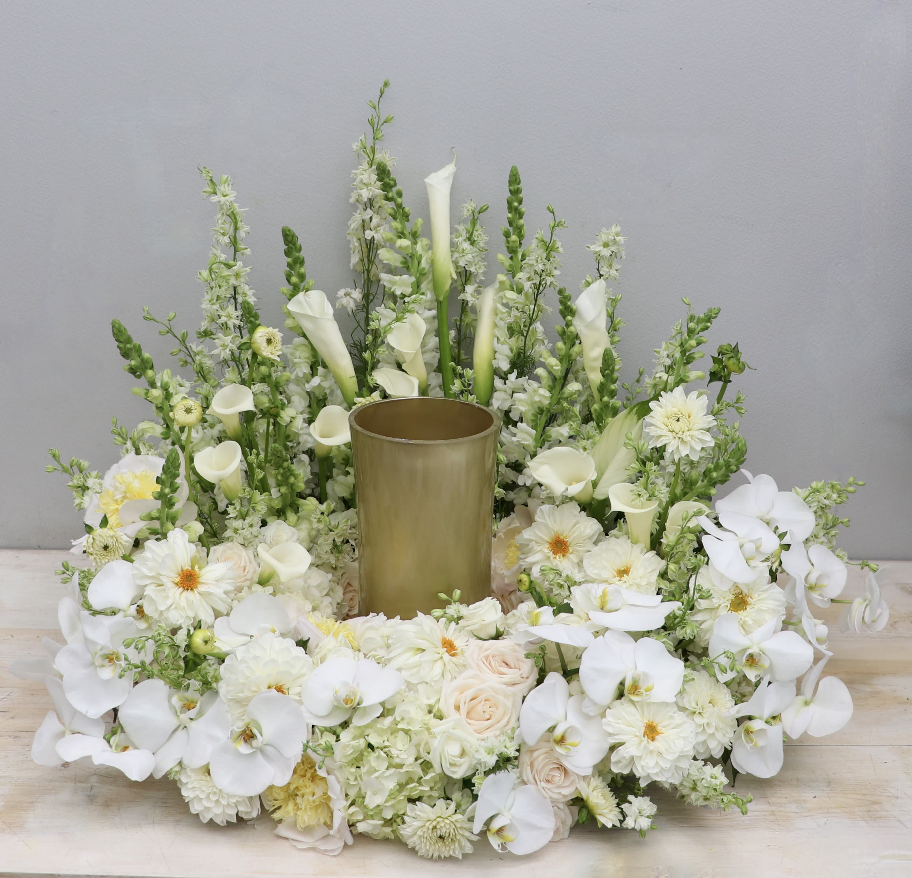 Everlasting Urn Wreath  - This urn tribute wreath includes a mix of orchids, roses, and seasonal greens. This urn wreath is made with greens and whites but you may request other colors in the special instructions during checkout.  Standard size is 20'', deluxe is 26'' and premium is 32''. Interior diameter is about 10'' for standard size. (Gold vase is placed for display - not included)