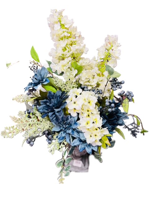 Serenity Silk Bouquet -  Description: Elegant and timeless, the Serenity Silk Bloom Arrangement features a sophisticated blend of soft ivory, cream, and deep blue faux florals. Accented with lifelike greenery and berry sprigs, this arrangement captures a natural, serene beauty that endures year-round. Displayed in a modern square container, it makes a perfect centerpiece or accent for home or office décor—offering lasting beauty without maintenance. 