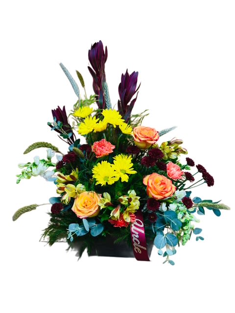 Golden Memories Floral Tribute - A warm and uplifting tribute designed to honor a beloved loved one. This elegant arrangement features cheerful yellow daisies, golden roses, burgundy accents, and touches of eucalyptus for a natural finish. Deep Leucadendron add height and grace, creating a beautiful balance of color and texture. 