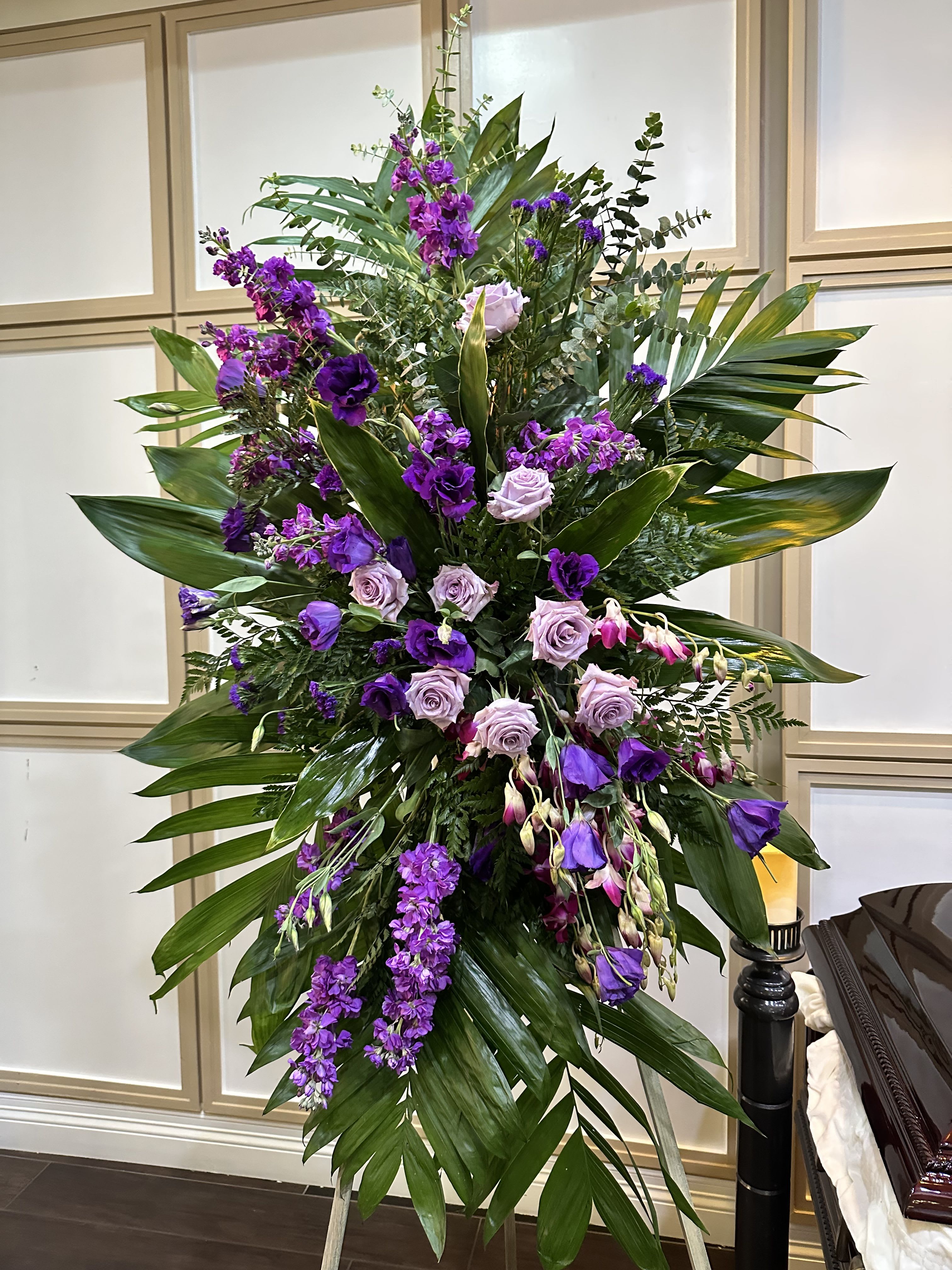 Lavender grace  Lavender grace  - It’s beautiful, matching side spray consisting of lavender roses, purple stock, and accent, flowers, orchids, tropical greens