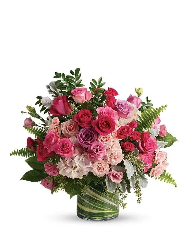 Rose Blush Garden Bouquet Rose Blush Garden Bouquet - Surprise someone special with this breathtaking bouquet of premium roses and elegant blooms. Designed to impress, this lush arrangement showcases a luxurious blend of pink, fuchsia, and cream hues, creating a full and vibrant display. A timeless gift perfect for any occasion, this stunning bouquet measures approximately 23" x 21".  Includes:  Pink, Hot Pink, Light Pink & Lavender Roses Spray Roses Hydrangea Lisianthus Seasonal Greens