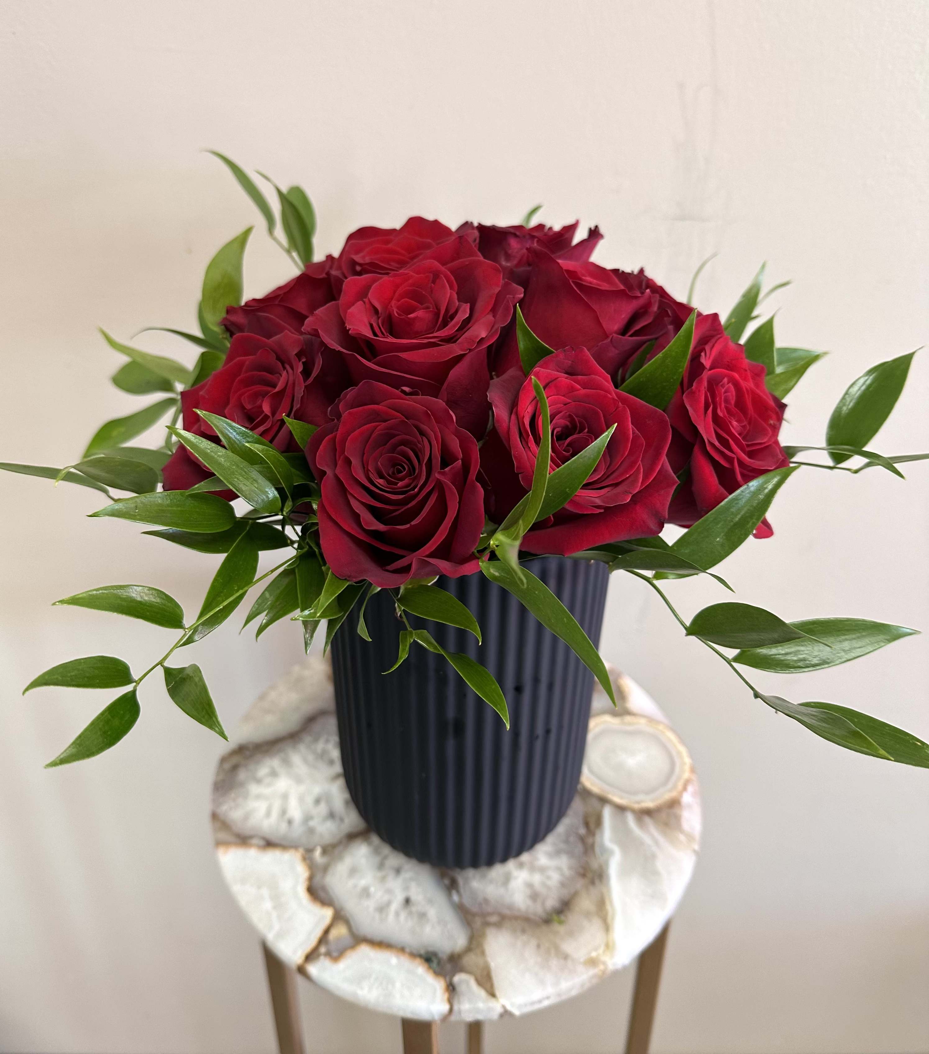 Velvet Passion Velvet Passion - Set the mood for an unforgettable Valentine’s Day with Velvet Passion, a breathtaking arrangement of a dozen deep red roses presented in a tall sleek, modern black vase. The rich contrast of velvety crimson petals against the bold black vessel exudes sophistication and desire, making this the ultimate statement of romance. Whether you're igniting new sparks or rekindling old flames, Velvet Passion speaks the language of love in the most seductive way.  Perfect for your Valentine, your secret admirer, or anyone who deserves a little extra passion this season.