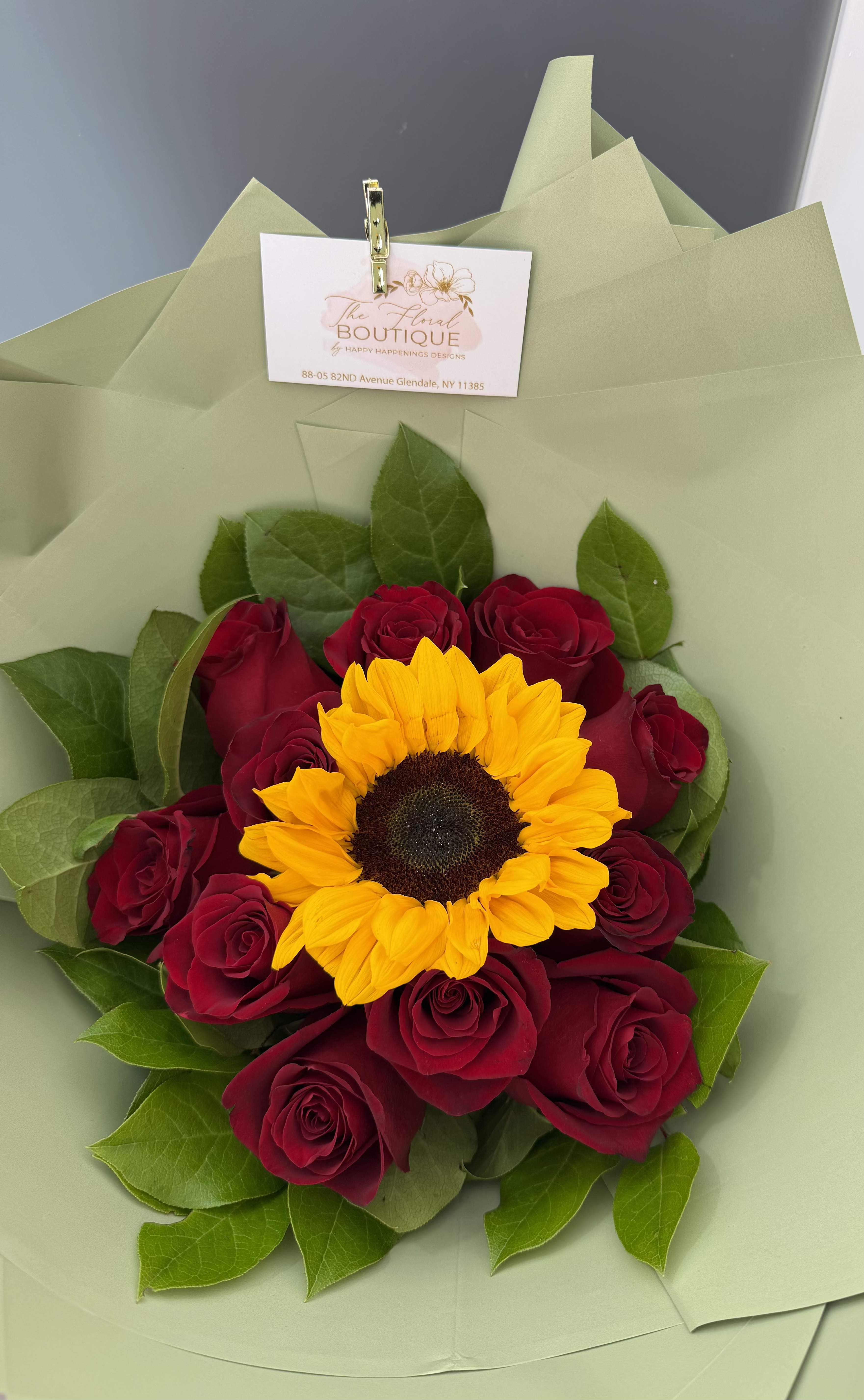 Sunshine & Romance Bouquet Sunshine & Romance Bouquet - A perfect balance of warmth and passion - our Sunshine & Romance Bouquet features a radiant sunflower surrounded by lush red roses, beautifully wrapped in our premium paper and finished with a satin ribbon. This vibrant arrangement symbolizes love, happiness, and admiration - making it an ideal gift for birthdays, anniversaries, or "just because" moments.  * Includes: 1 bright sunflower 12 Fresh premium red roses Elegant greenery accents Wrapped in premium paper with satin ribbon  Roses colors can be adjusted to your preference upon request