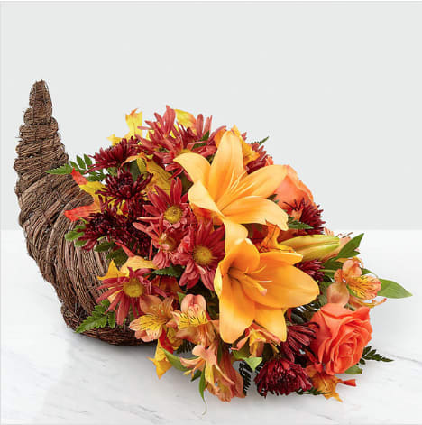 Harvest Comfort Cornucopia - Whether you're saying &quot;Wish I could be there,&quot; or &quot;You're the greatest host,&quot; our Harvest Comfort Cornucopia shares every message of gratitude during Thanksgiving. A natural, woven cornucopia is filled with beautiful fall collection. Make their day and delight their home with our stunning Autumn arrangement. All Around Standard 9&quot;Hx13&quot;W DX 10&quot;Hx16&quot;W PM 11&quot;Hx18&quot;W