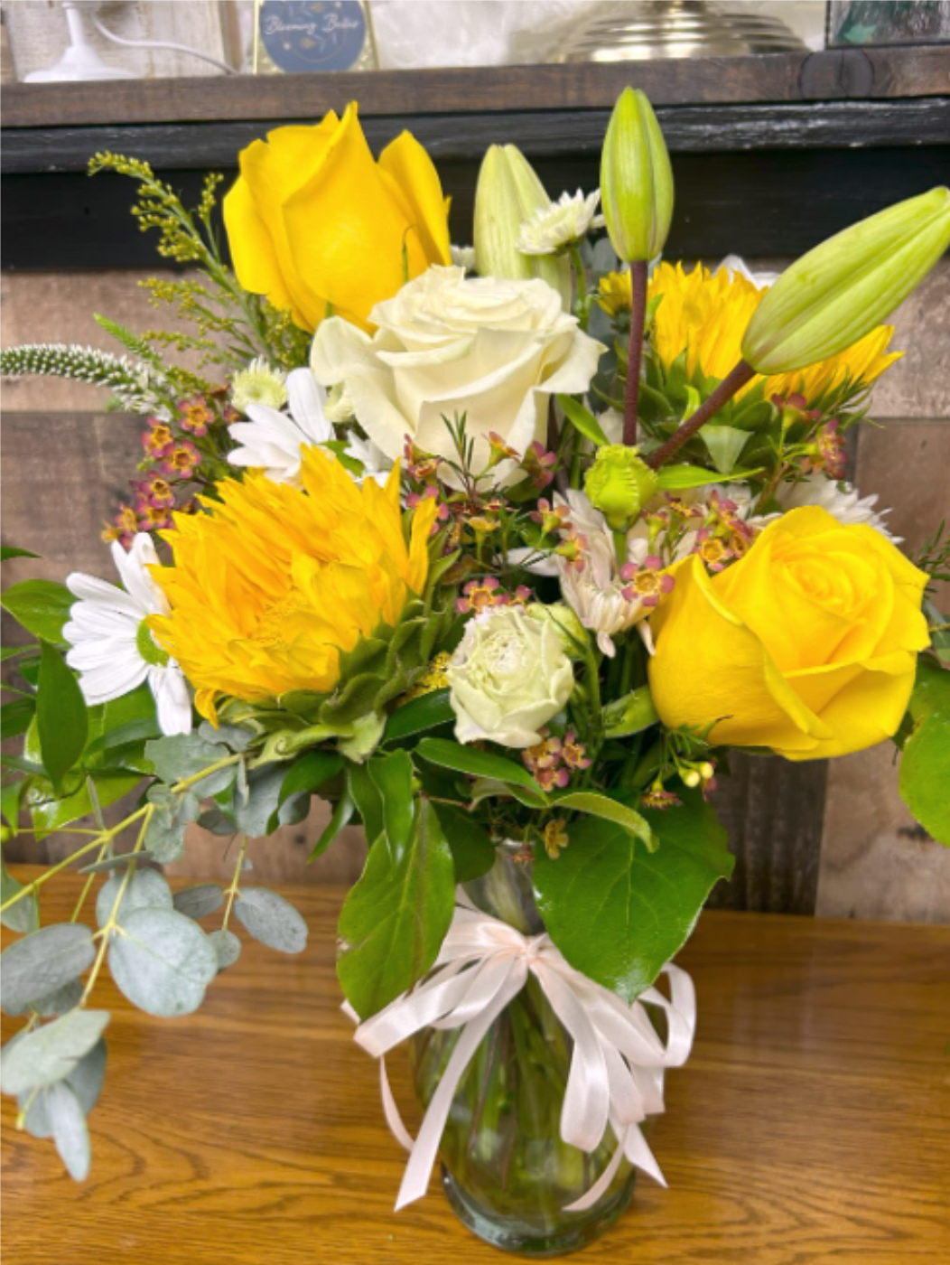 Classy Wildflowers - A vibrant bouquet combining roses, daisies, and sunflowers.