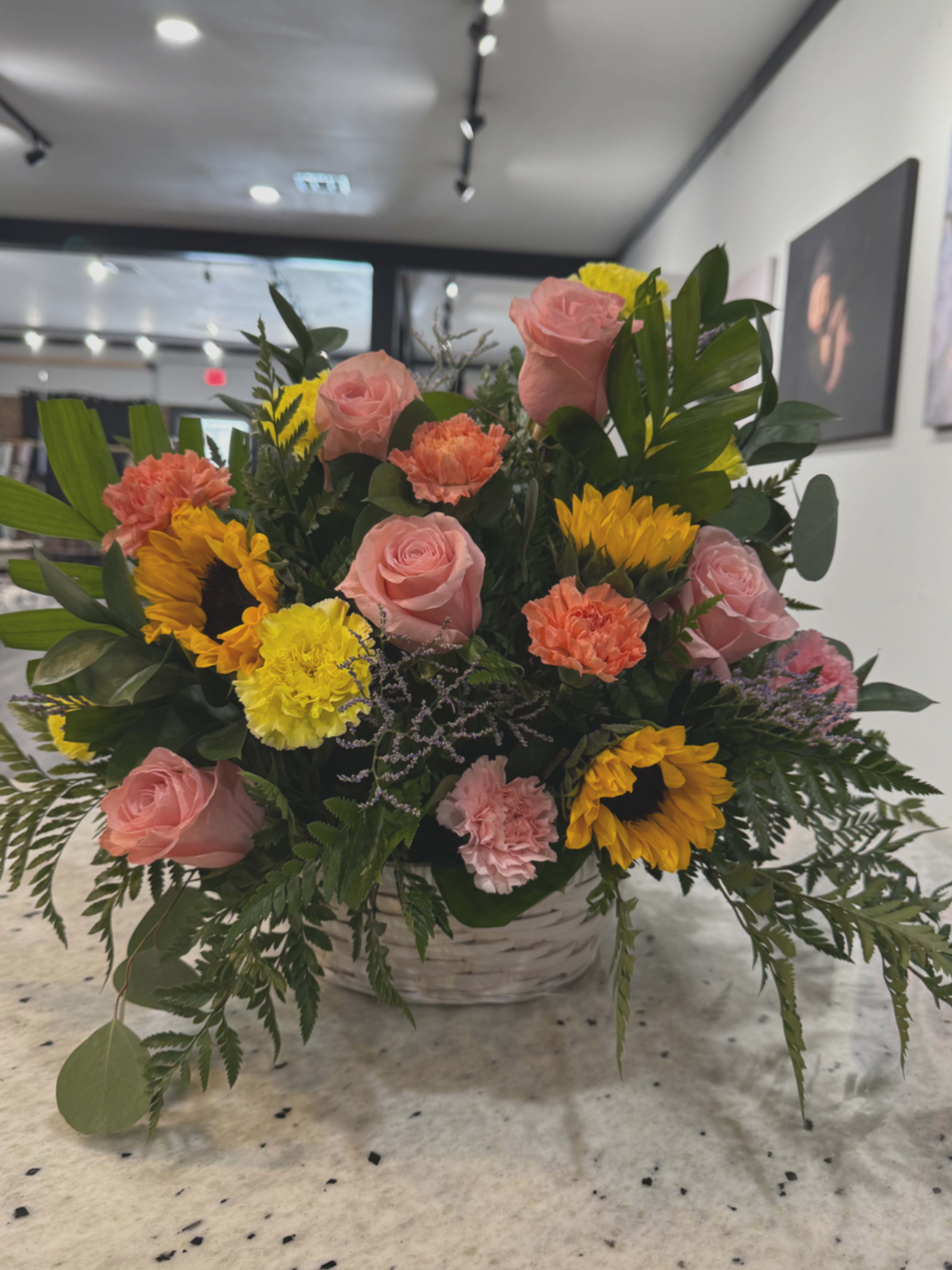 Sunshine Basket - Spread a little sunshine in someone’s life. Send them this big, beautiful floral gift of gentle blossoms in pastel shades of pink, blue and sunlight yellow – arranged in a rustic basket – and they’ll remember your thoughtfulness for a long time to come.