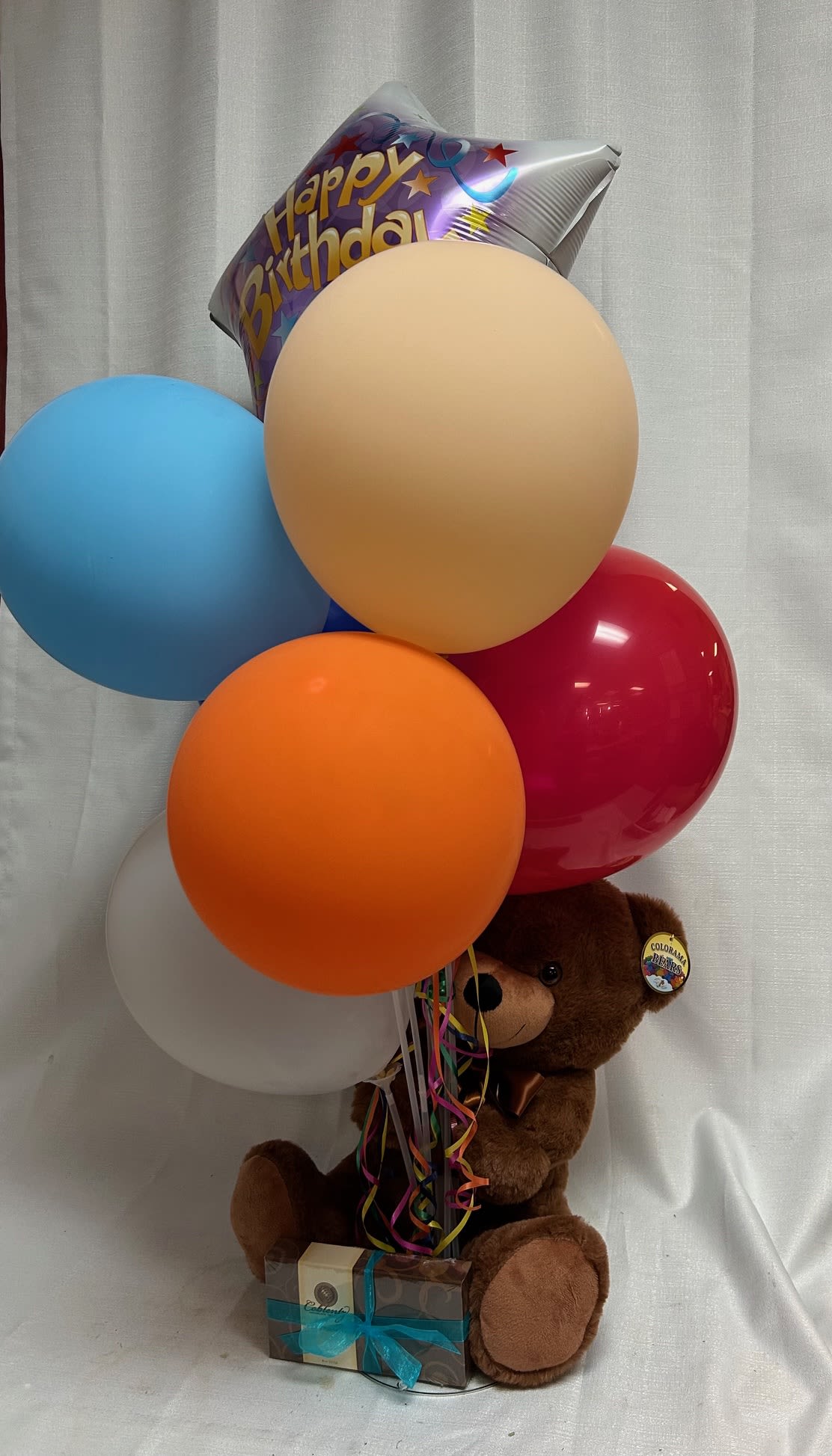 Celebration Tower Bundle - Send a bundle of happiness! This tower comes with one helium balloon and 6 latex balloons, a stuffed bear and a 4 oz. box of chocolates. The default occasion is birthday but you can let us know if you want the helium balloon to have a different message. Other options: I love you, Happy Anniversary, Get well, Thinking of you, Congratulations, You're special. 
