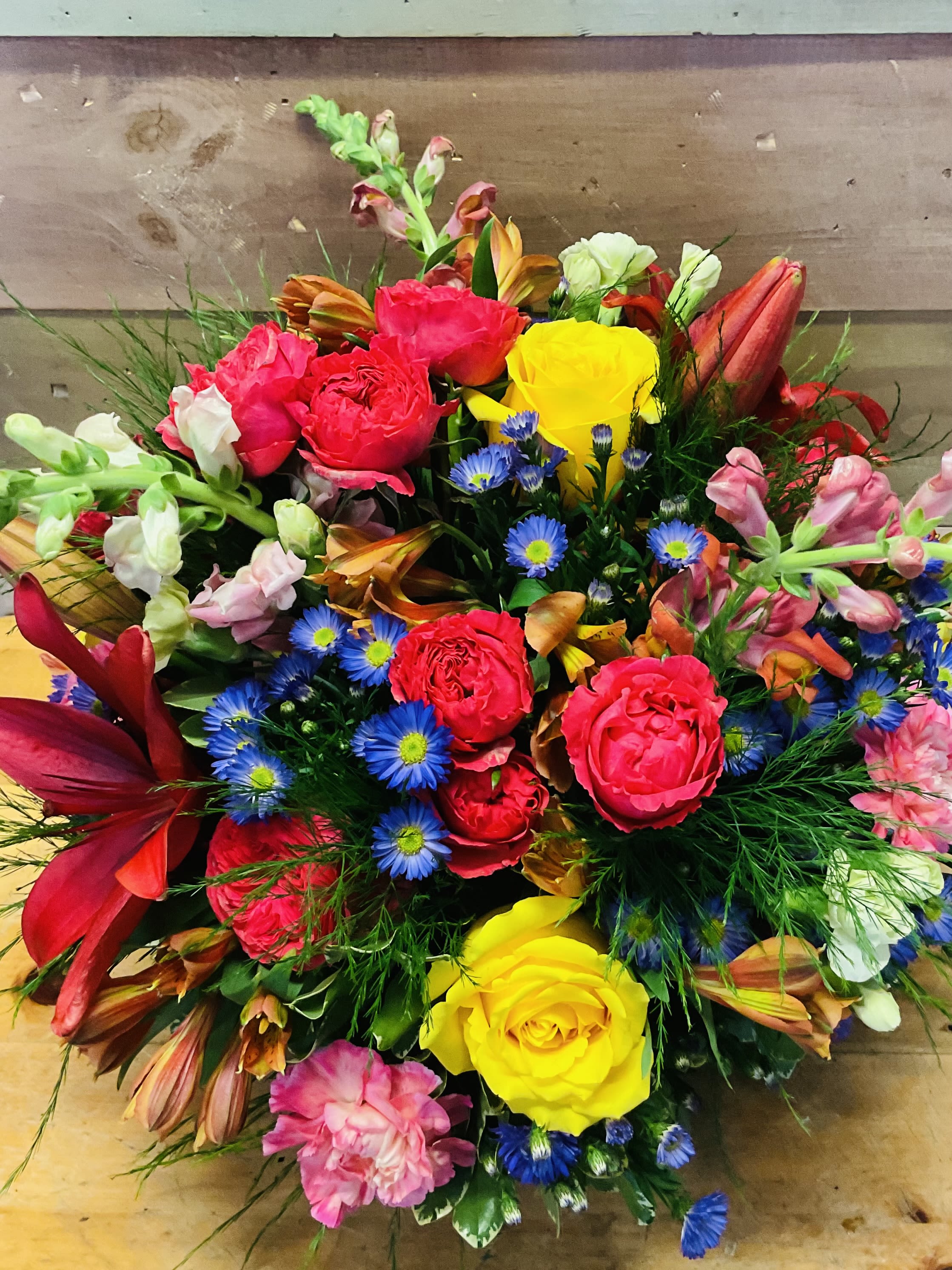 Carnival  - A mix of the freshest flowers that are in season, popping with bright colors. This is presented in a 360 all around arrangement.