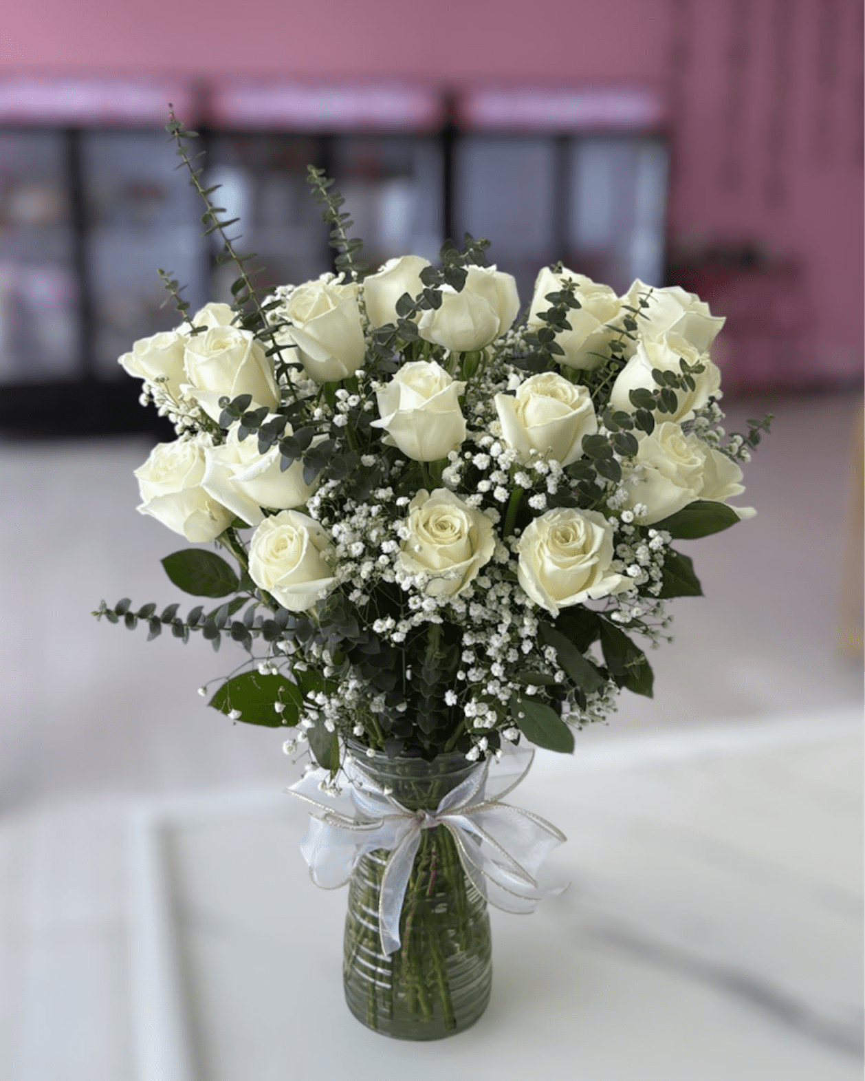 Two Dozen White Roses - Two dozen white roses are a classic gift! Perfect for Valentine's Day, an Anniversary, or any type of celebration.  Please note that florists may need to make substitutions based on inventory to ensure the freshest blooms are delivered, while maintaining the arrangement's overall aesthetic.