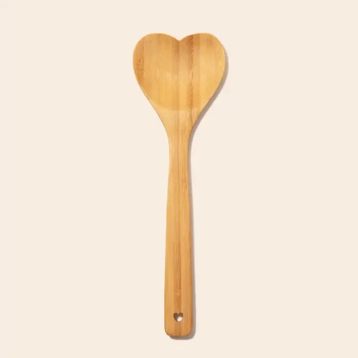 HEART SHAPED BAMBOO SERVING SPOON - Add a touch of love to your kitchen with this beautifully crafted bamboo heart spoon, perfect for stirring, serving, and gifting to the cooking enthusiast in your life. Made from sustainable bamboo, this eco-friendly and biodegradable spoon is a natural alternative to plastic utensils, supporting a zero-waste lifestyle.
