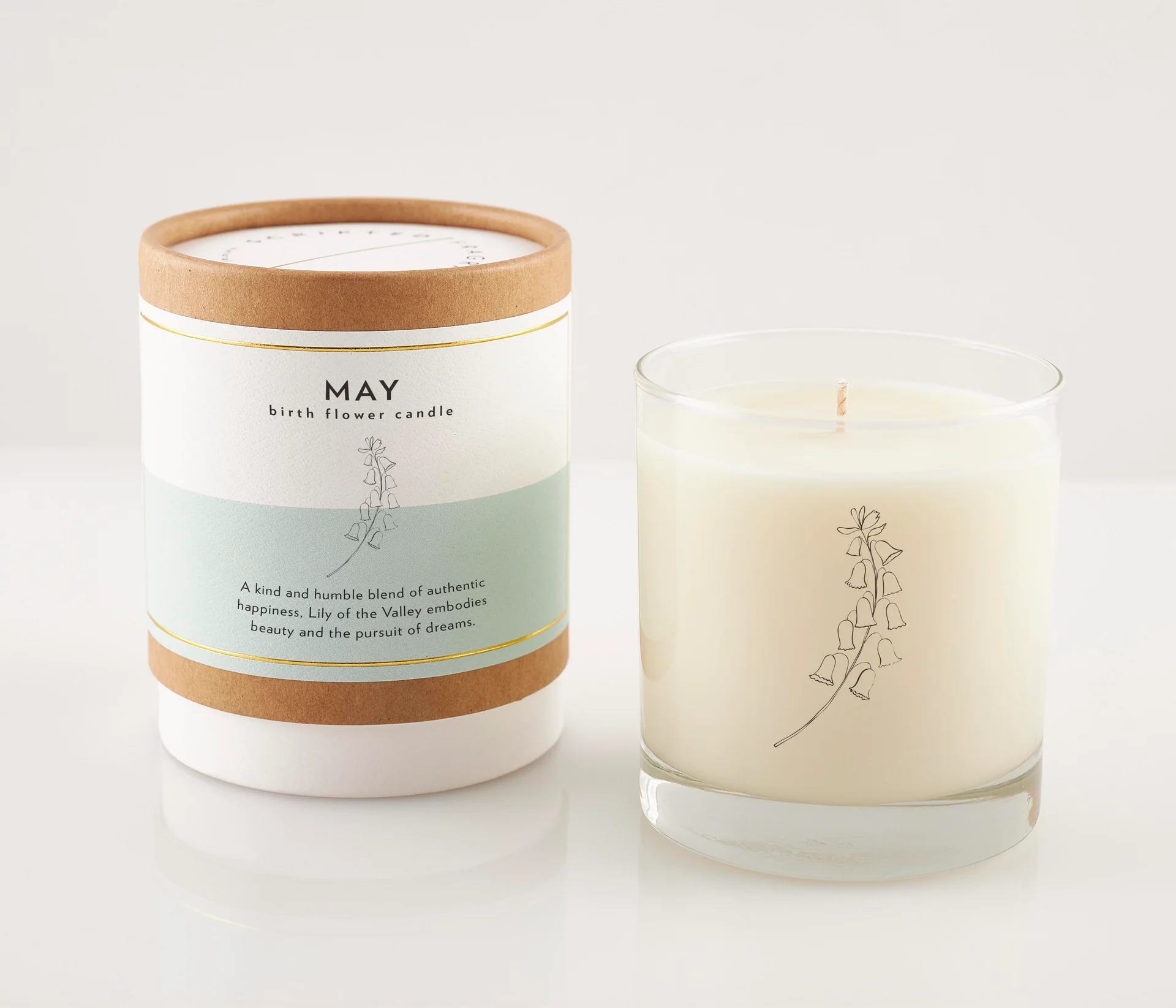 May Birth Month Flower Soy Candle, Lily Candle - Celebrate the beauty of May and the unique charm of birth month flowers with our May Birth Month Flower Soy Candle. Inspired by the enchanting Lily of the Valley, the symbol of May, this candle is a perfect tribute to those born in this vibrant month or as a thoughtful gift for a loved one celebrating their special day.  A reusable rocks glass, adorned with a printed black flower silhouette, offering a modern and sophisticated vessel that can be enjoyed long after the candle has burned away. Packaged in an eco-friendly gift box embellished with modern gold foil, it serves as a stylish and sustainable choice for gifting.  Candle details: Hand poured, 100% soy wax Features a lead-free cotton wick Made with premium fragrance and essential oils Vegan and cruelty-free Free from dyes, additives, preservatives, petroleum, and harmful phthalates Reusable Rocks Glass is hand wash only Reusable Rocks Glass Candle Diameter | 3.5 in Height | 4 in Net Weight | 8 oz Up to 50 hours of burn time