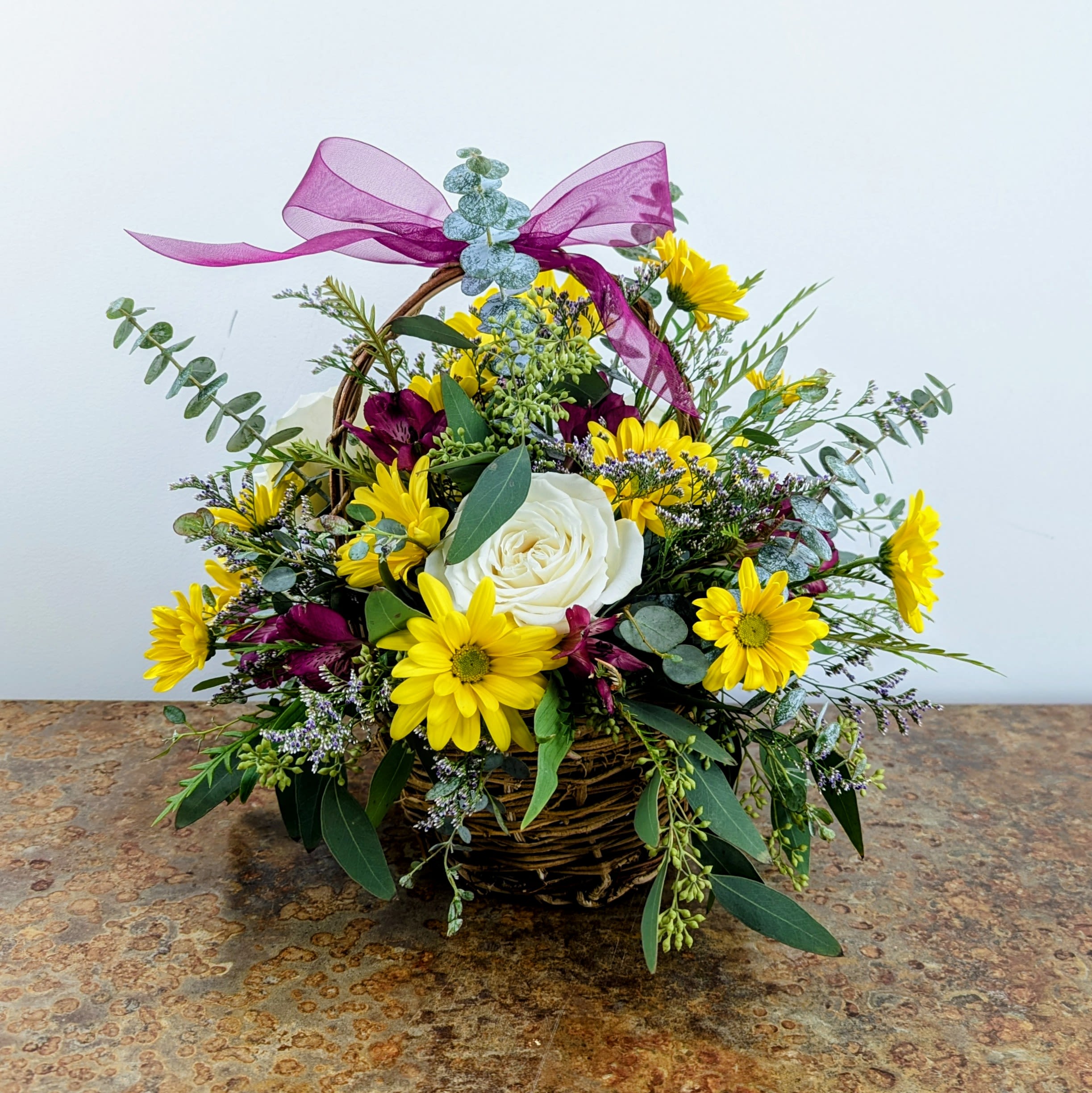 Meadow Melody - Six inch wicker basket with daisies, roses, alstro and greens make this a perfect gift for any occasion!