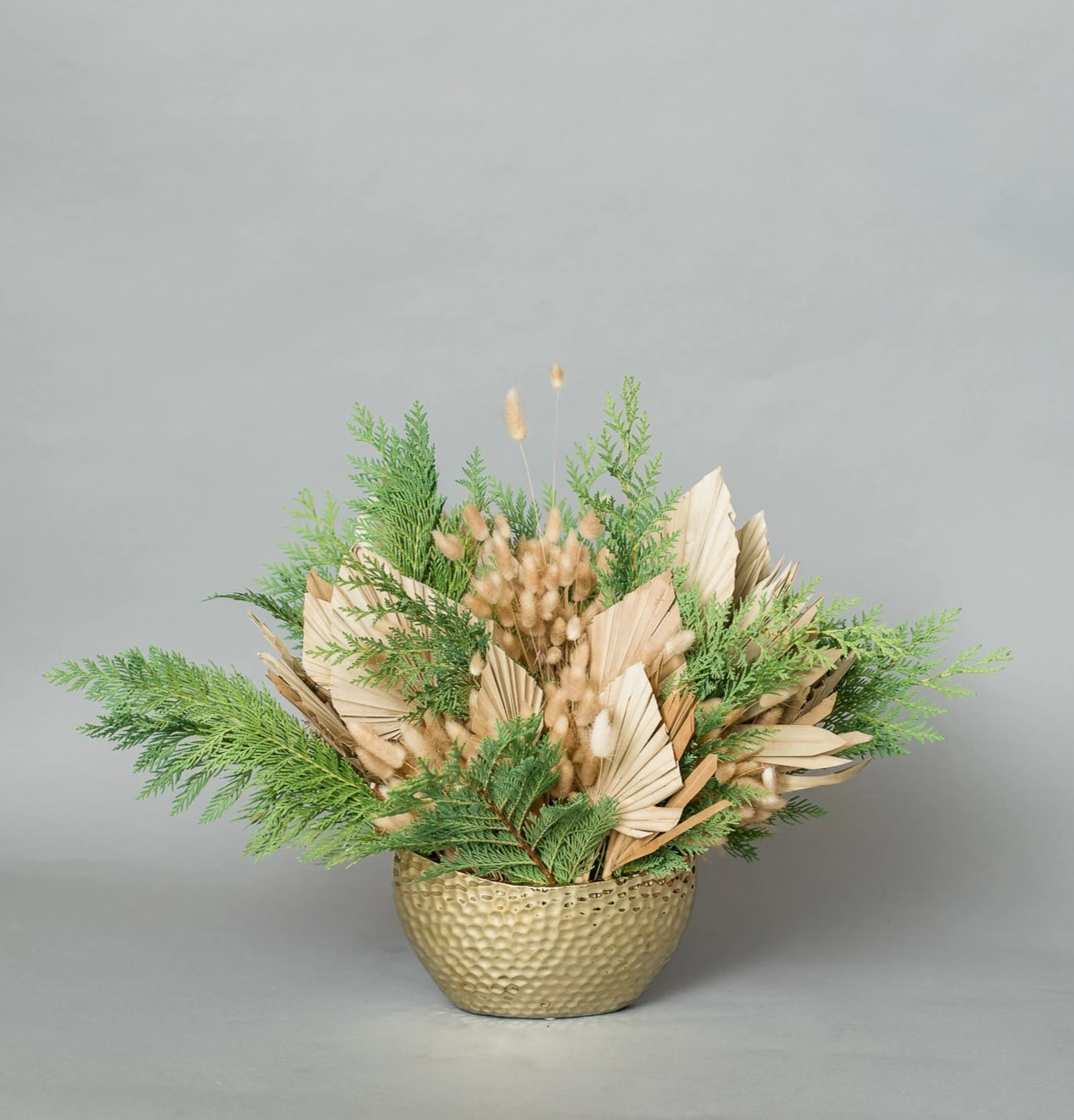 Christmas in September - Get in the Holly Jolly Spirit with our dreamy Holiday Collection! Inspired by the warmth and memories of holidays past, Christmas in September comes arranged with a variety of dried textures accented with holiday greens, all eloquently arranged in one of our hand-picked designer vases.  Pictured [DELUXE]  *Some items in this arrangement must be special ordered, please allow 1-2 weeks notice to allow time for arrival of special items, otherwise, substitutions will occur.*