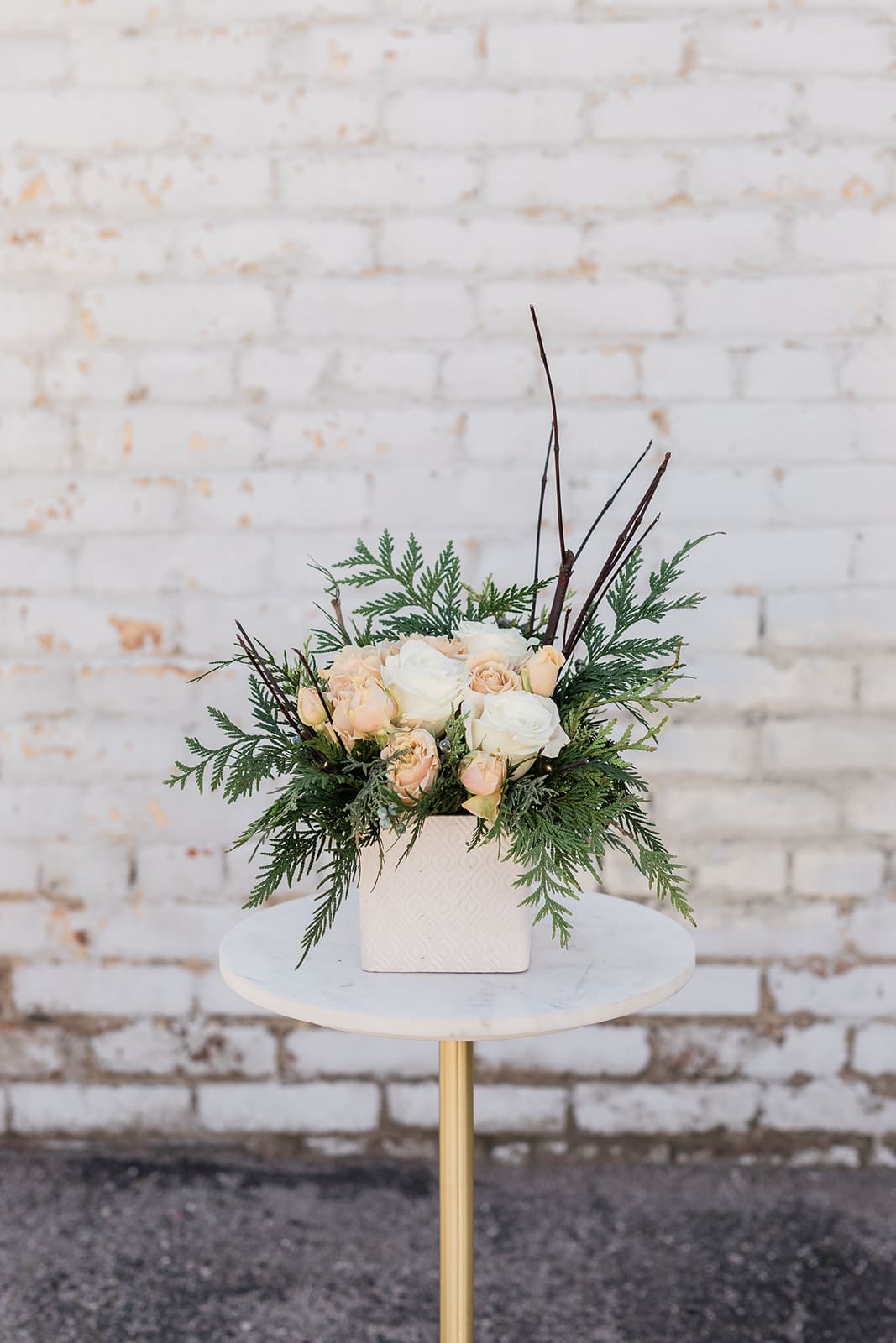 Christmas Magic - Cozy on up and Drink in the Holiday Spirit with our new Winter Collection! Designed to capture the essence of the holidays and bring joy to all. Bring the Christmas Magic home with you this season. Arranged with a stunning mix of white and neutral premium blooms, accented by winter greens all elegantly designed in one of our hand-picked designer vases.  Pictured is [STANDARD]  *Some items in this arrangement must be special ordered, please allow 1-2 weeks notice to allow time for arrival of special items, otherwise, substitutions will occur.*