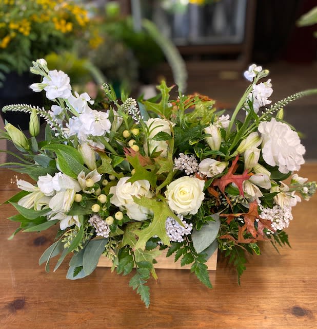 fall elegance - this arrangement is a sophisticated blend of white, cream, and peach, with fall leaves. Something to enhance any ones home.