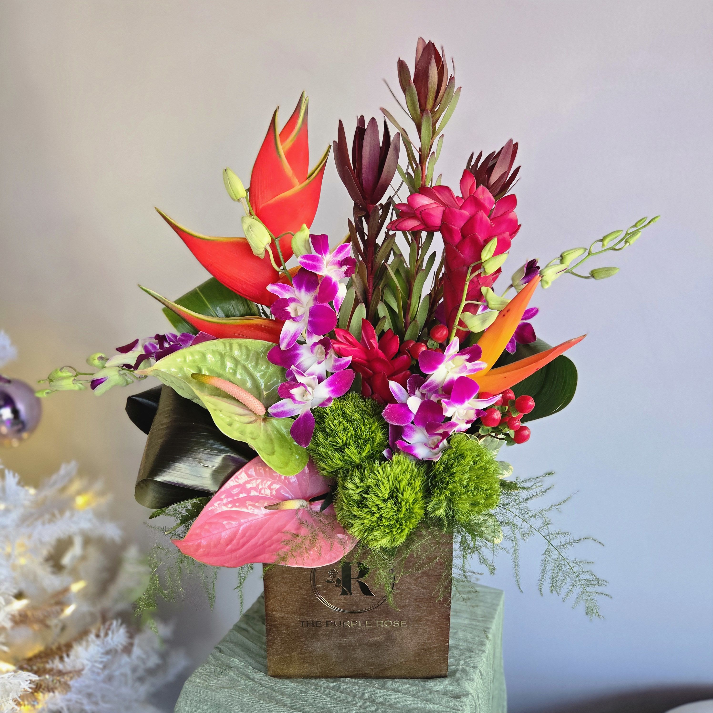 91- First Class  - This tropical arrangement is perfect for your traveling friend, business partner, or anybody who just wants to get away. Featuring birds of paradise, orchids and anthurium in a sleek black cube. First Class  is a stylish tropical paradise.  