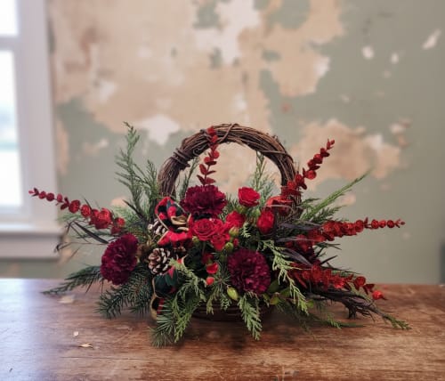 Christmas Wreath - Welcome to Specialty Floral Design, Olympia's premier destination for exquisite floral creations! Embrace the holiday spirit with our enchanting Christmas Wreath, meticulously handcrafted in the heart of Olympia, WA. Our wreath, a symbol of eternal hope and joy, embodies the essence of the festive season while proudly supporting our local artisans and community.  What sets our Christmas Wreath apart is not just its festive design, but also the passion and expertise poured into each arrangement. At Specialty Floral Design, we take pride in using locally sourced materials, ensuring freshness and authenticity in every element. From the grapevine base representing the circle of life to the carefully selected burgundy carnations, red roses, and winter pinecones, our wreath is a testament to both tradition and innovation.  Surprise your loved ones this Christmas with a gift that radiates warmth and holiday cheer. Order now and enjoy the convenience of our same-day delivery service throughout Olympia, Tumwater, and Lacey, WA. Let us bring the magic of the season directly to your doorstep, spreading joy and delight to those who matter most.  Elevate your holiday gifting experience with our Christmas Wreath - a unique fusion of local craftsmanship, timeless beauty, and the everlasting spirit of Christmas.  Order now and make this holiday season truly unforgettable! 