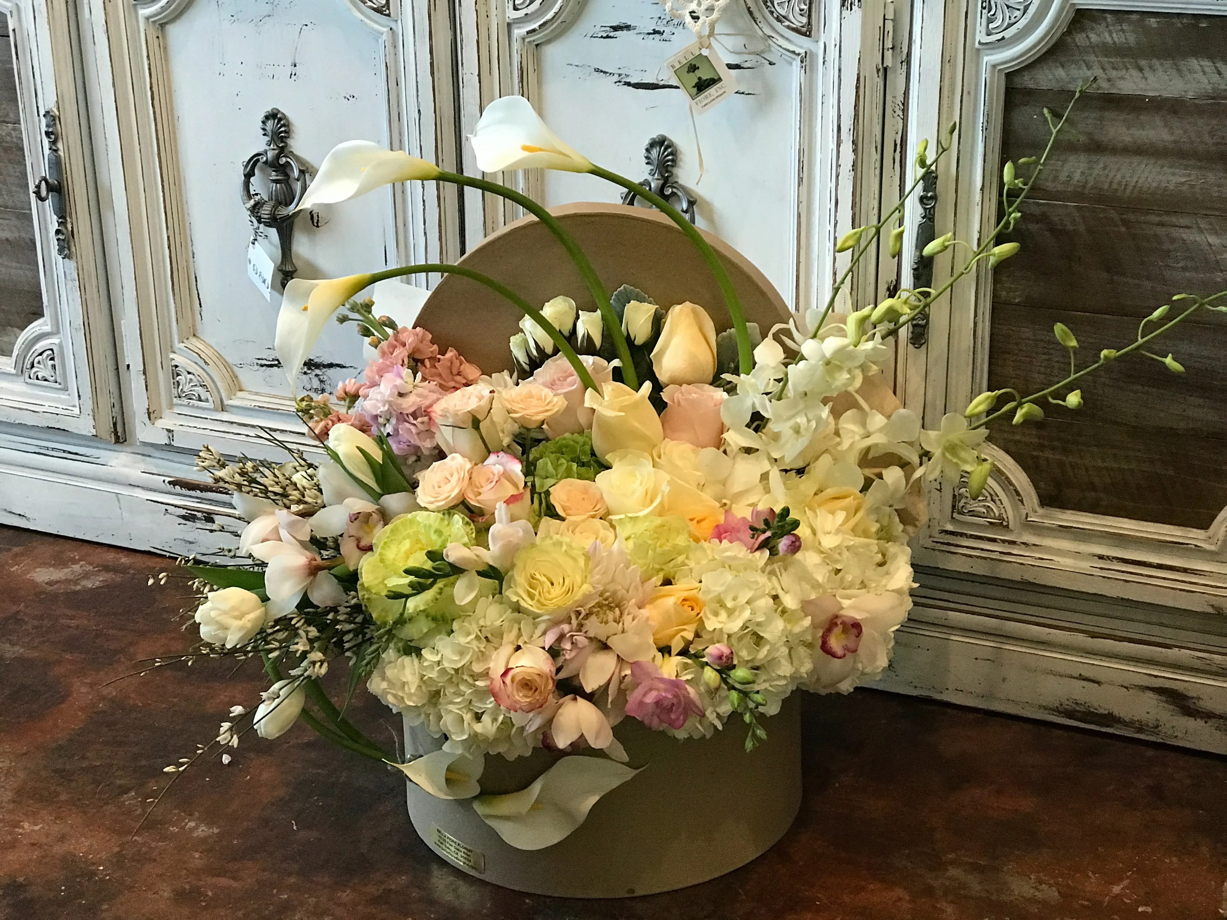 Bundle of Joy Bundle of Joy - A lovely arrangement of White hydrangeas, calla lilies, roses, dendrobium orchids, cymbidium orchid, tulips and much more flowers in a round gift box that will bring a little joy in everyones day.