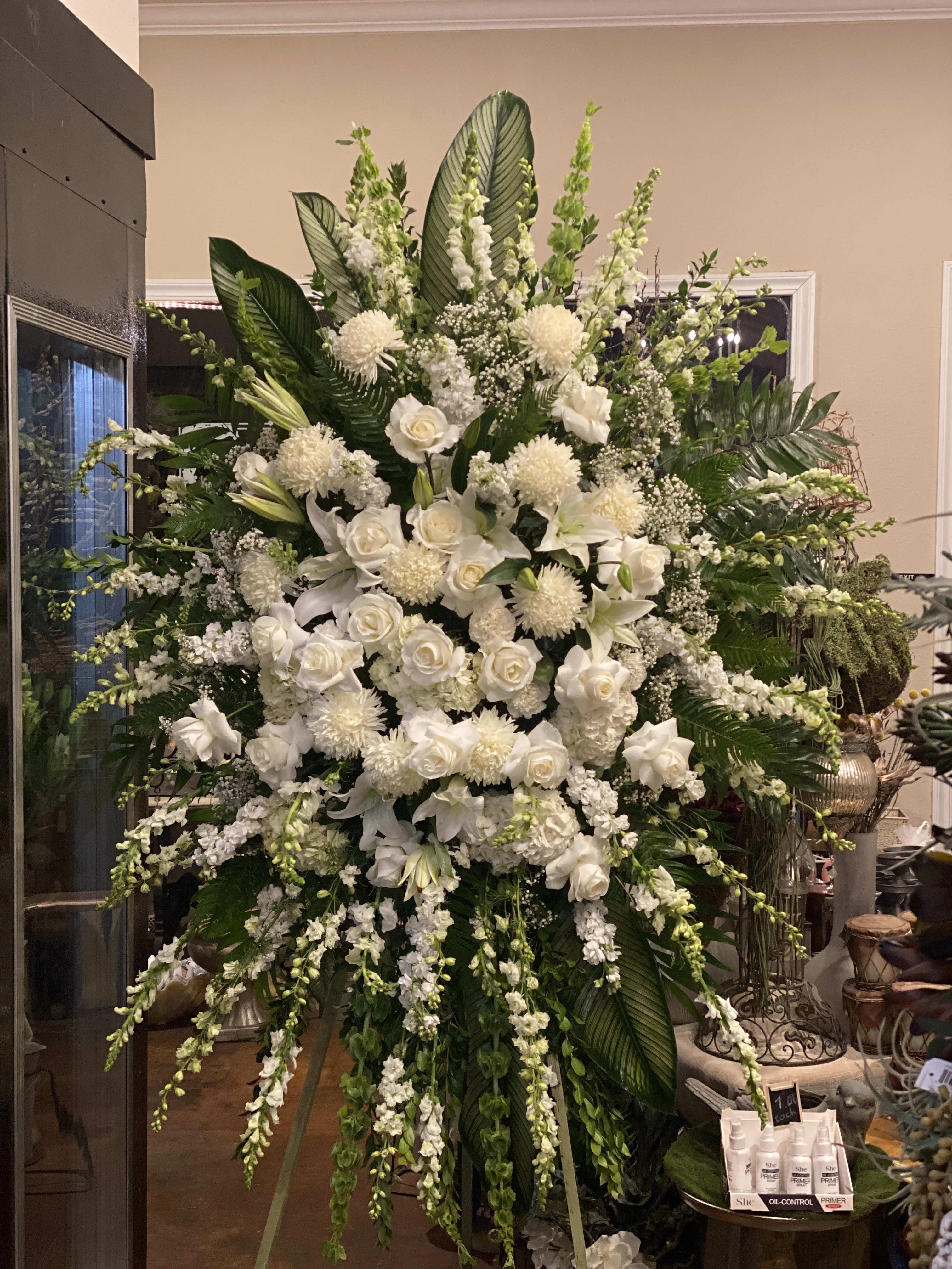 The Loving Thoughts Standing Spray The Loving Thoughts Standing Spray - The Standing Spray beautifully captures the message you want to send during times of sensitivity. Crafted with classic, statement white and ivory blooms like lilies, roses and snapdragons, this arrangement is the perfect expression of respect.