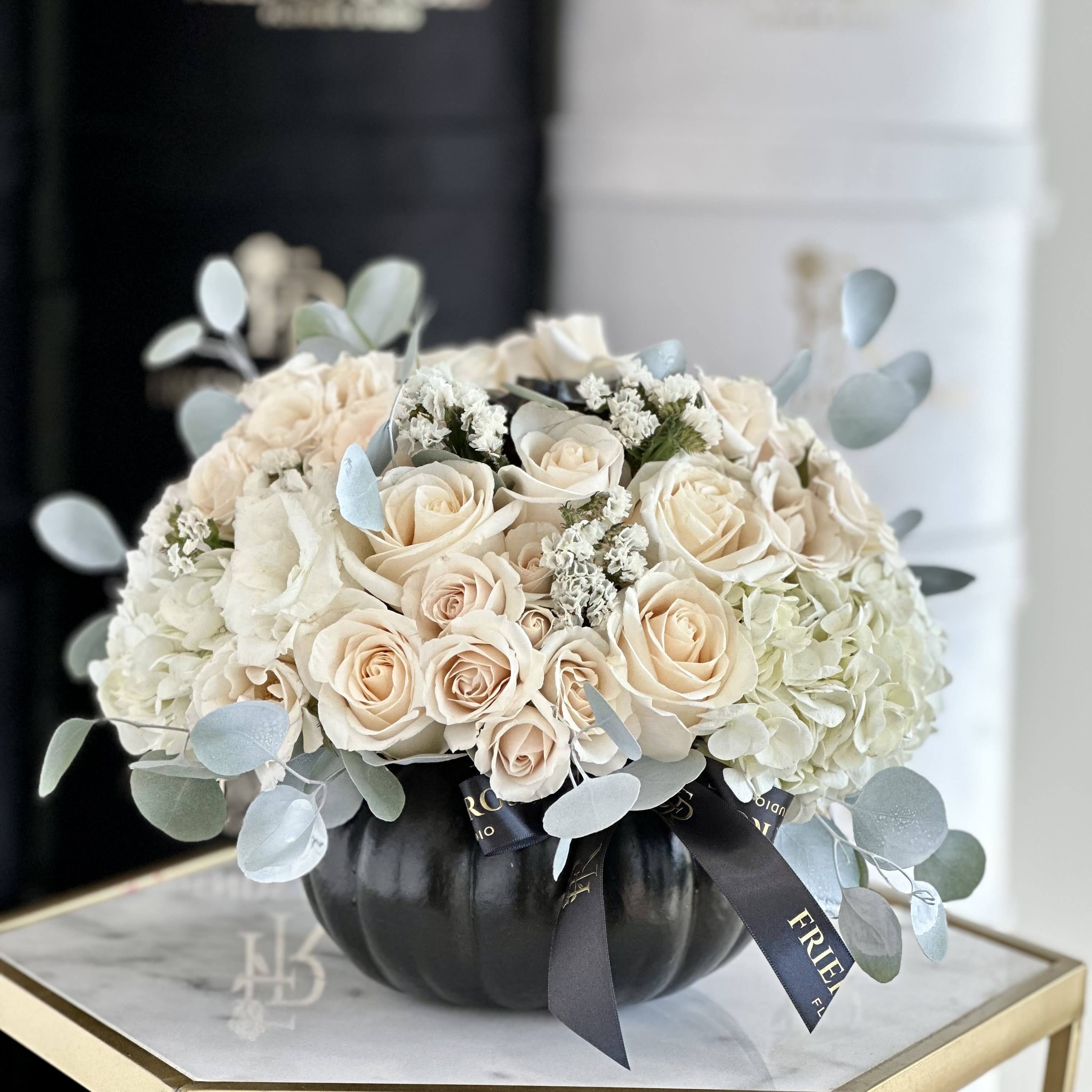 Midnight Elegance - A chic modern arrangement of white roses in a sleek black pumpkin. Elegant, soft, and timeless - the perfect accent for contemporary interiors or fall decor.