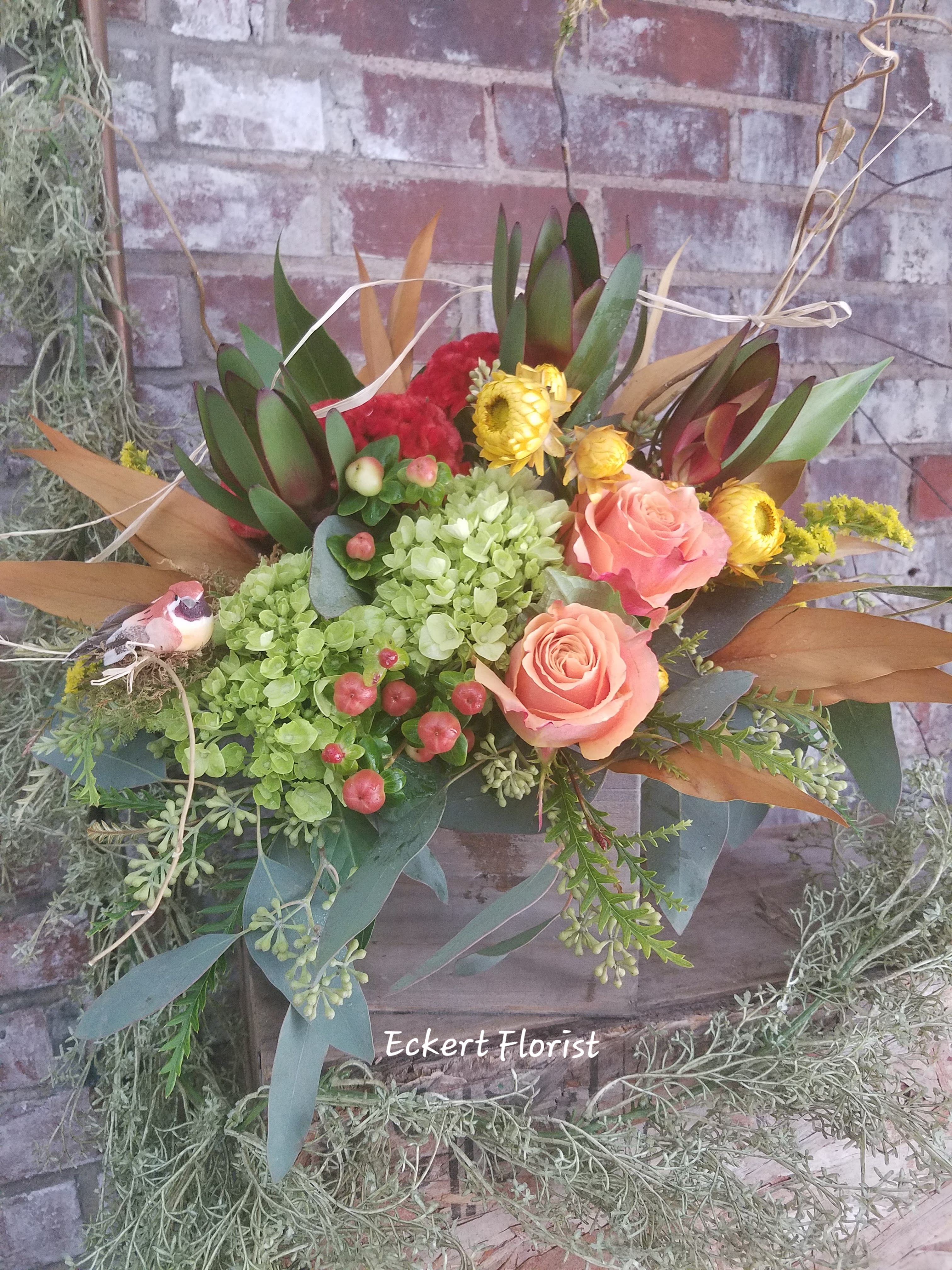 Eckert Florist's Happiness by BloomNation™ - This arrangement likes two things: being inside of a box and delivering happiness in the form of fall flowers. And it’s already inside of a box. Do this arrangement a favor and let it deliver happiness to someone. Order one today! *Flowers, container, and colors will vary 