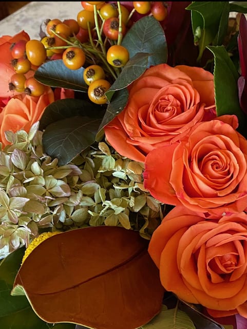 Designer's Choice Warm Citrus Palette - A variety of seasonal blooms in shades of pear, tangerine, ochre. Blooms will vary, but may include antique hydrangea, roses, magnolia leaf, berries. 