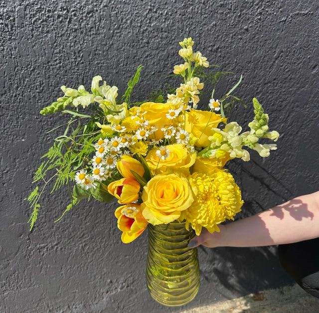 Ray of Sunshine Arrangement - Looking to brighten someone’s day? Our Ray of Sunshine Arrangement is the perfect choice. This cheerful arrangement features a vibrant mix of yellow blooms, expertly hand-arranged to radiate warmth, joy, and positivity. Whether you're celebrating a birthday, sending get well wishes, or delivering a &quot;just because&quot; surprise, this arrangement is sure to lift spirits.  Each arrangement is crafted with care by our skilled floral designers using the freshest seasonal flowers—many sourced from Maryland flower farms. We offer fast, reliable flower delivery in Baltimore, including same-day service throughout Baltimore City and surrounding counties.  Proudly serving the community since 1961, The Flower Cart is your local Baltimore florist, known for quality, creativity, and heartfelt service. Let us help you connect, comfort, and celebrate with flowers made to make moments brighter.