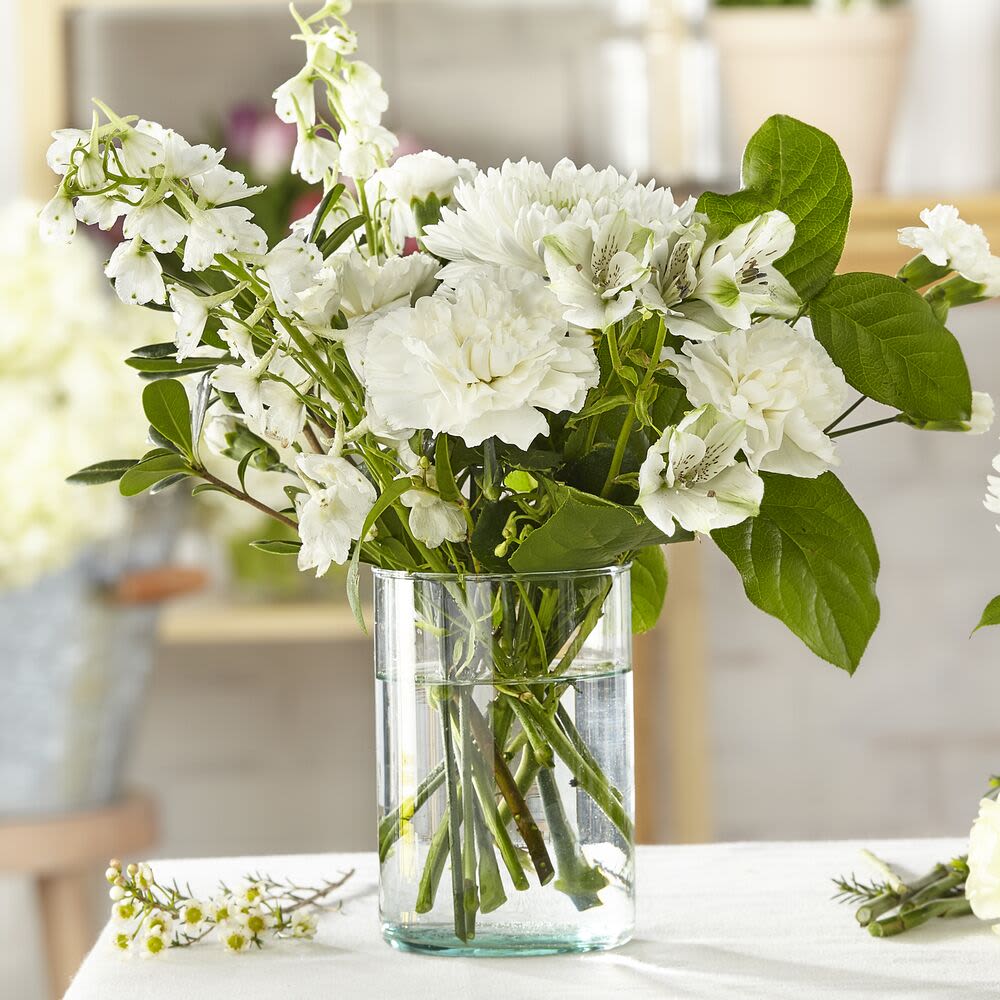 Classic Ivory Flower Bouquet - Elevate any occasion with the timeless elegance of the Classic Ivory Flower Bouquet. Expertly crafted and designed by our florist, this bespoke arrangement showcases the finest-quality blooms in soft, neutral tones.  While the exact design and floral varieties may vary due to freshness and availability, each bouquet is thoughtfully arranged to ensure a unique and stunning presentation. Perfect for celebrating life’s special moments or sending a heartfelt gesture, this bouquet is a true classic.  Order the Classic Ivory Flower Bouquet today and let our florists create a one-of-a-kind masterpiece tailored just for you.