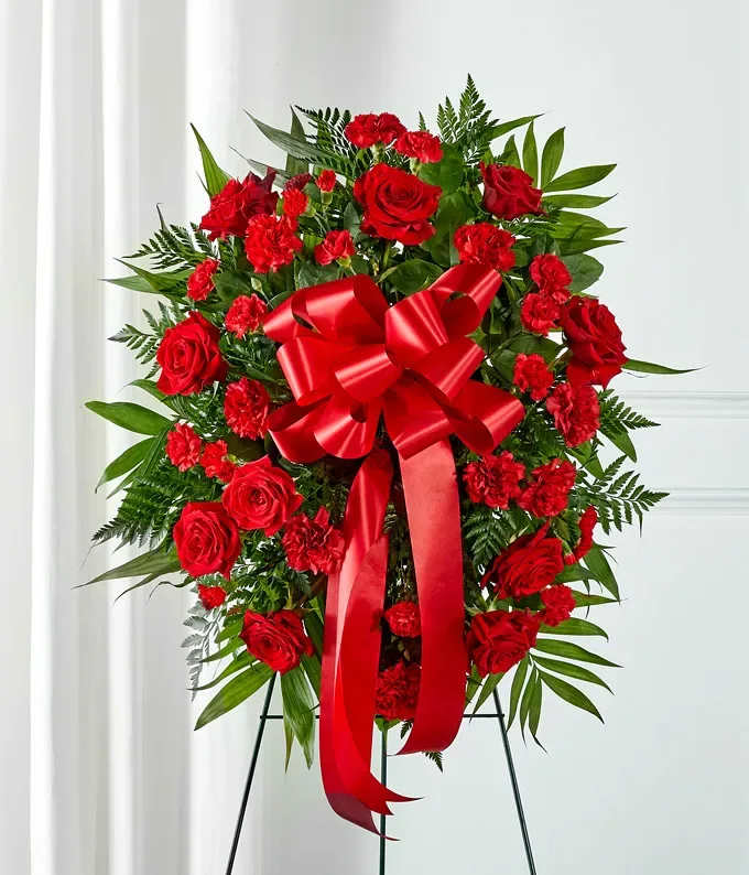Red Flowers Standing Spray - This Red Flower Standing Spray is hand arranged by DGM Flowers with stunning red flowers. Standing sprays are a wonderful way to let someone know you are thinking of them during this difficult time. Created with red roses, carnations and a decorative ribbon. Measures 21&quot;H by 32&quot;L.  Includes: • Red Roses &amp; Carnations • Hand Delivered • Decorative Red Bow  