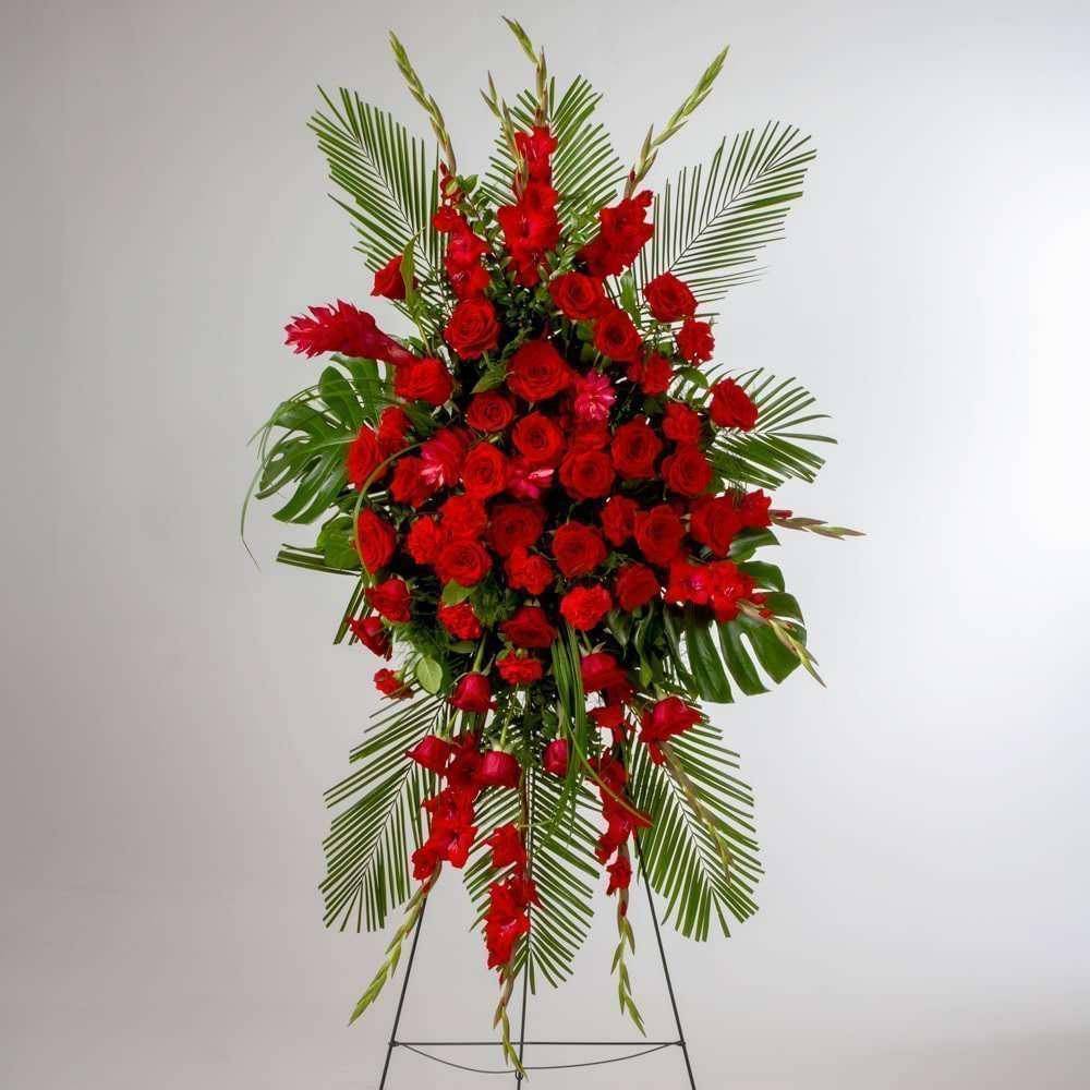 Forever Feelings Spray - Elevate your condolences with Forever Feelings Spray by DGM Flowers | Fort Lauderdale Florist. This stunning funeral sprays near me proudly showcases premium fresh cut flowers, expertly arranged to convey sympathy and comfort. Red is the color of love and this Forever Feelings standing spray displays it with luxurious style. Red roses and palms come together with other red and greenery to create a beautiful salute.