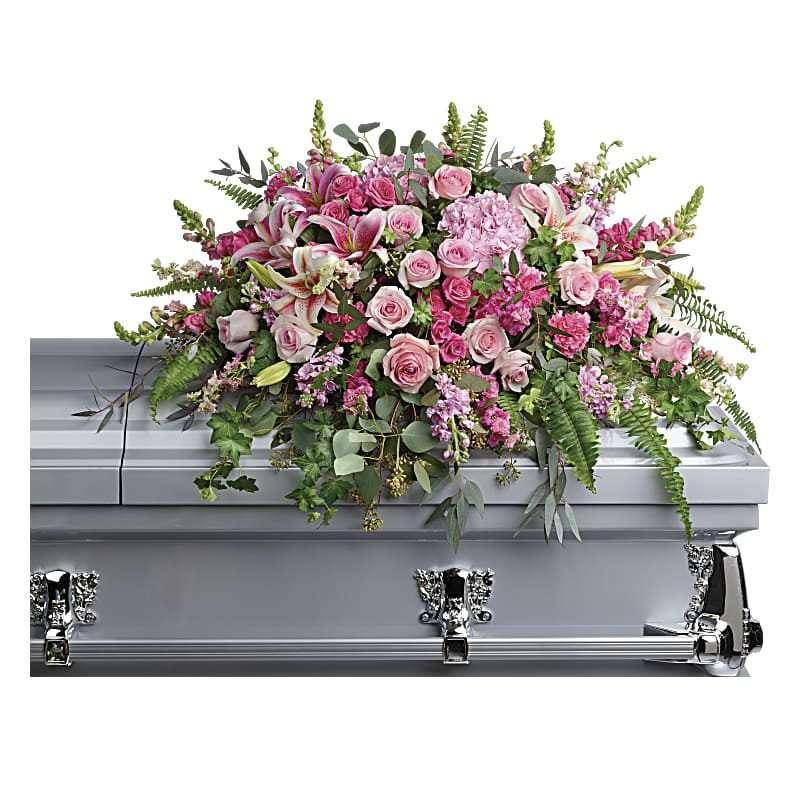 Beautiful Memories Casket Spray - Pay tribute to your beautiful memories with this breathtaking spray of pink hydrangea, roses and lilies. At once dramatic and delicate, it's a feminine reminder of life's greatest love. &nbsp;The perfect funeral casket spray to honor and remember your loved one in a beautiful way.  This dramatic spray features pink hydrangea, pink roses, pink spray roses, pink stargazer lilies, pink carnations, pink larkspur, pink snapdragons, pink stock, green ivy, sword fern, silver dollar eucalyptus, seeded eucalyptus, and lemon leaf.