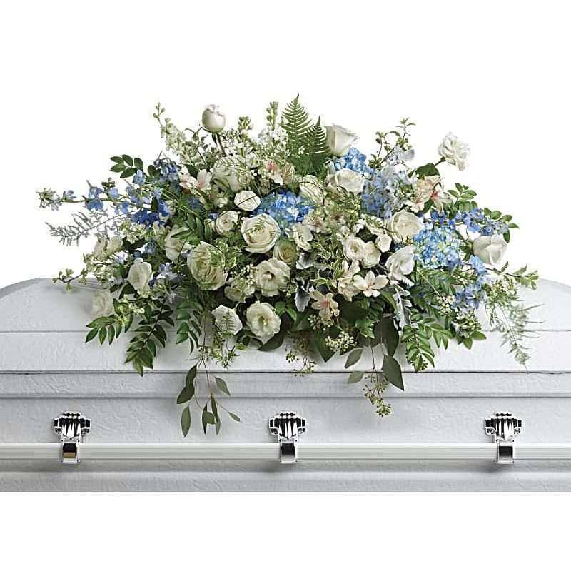 Tender Remembrance Casket Spray - The Tender Remembrance Casket Spray by DGM Flowers | Fort Lauderdale Florist is a beautiful tribute to a loved one during a funeral service. Like wisps of clouds in a bright blue sky, this breathtaking spray of hydrangea, roses and alstroemeria refreshes and inspires. A beautiful way to remember your loved one. This funeral casket spray flowers is a symbol of love and remembrance, making it a fitting choice to honor and celebrate the life of the departed.  This stunning spray includes blue hydrangea, white roses, white spray roses, white alstroemeria, white lisianthus, blue delphinium, white larkspur, white stock, white waxflower, dusty miller, huckleberry, asparagus plumosus, pitta negra, lily grass, dagger fern, and lemon leaf. SIZES:&nbsp;24&quot; H X&nbsp;36&quot; W   &nbsp;