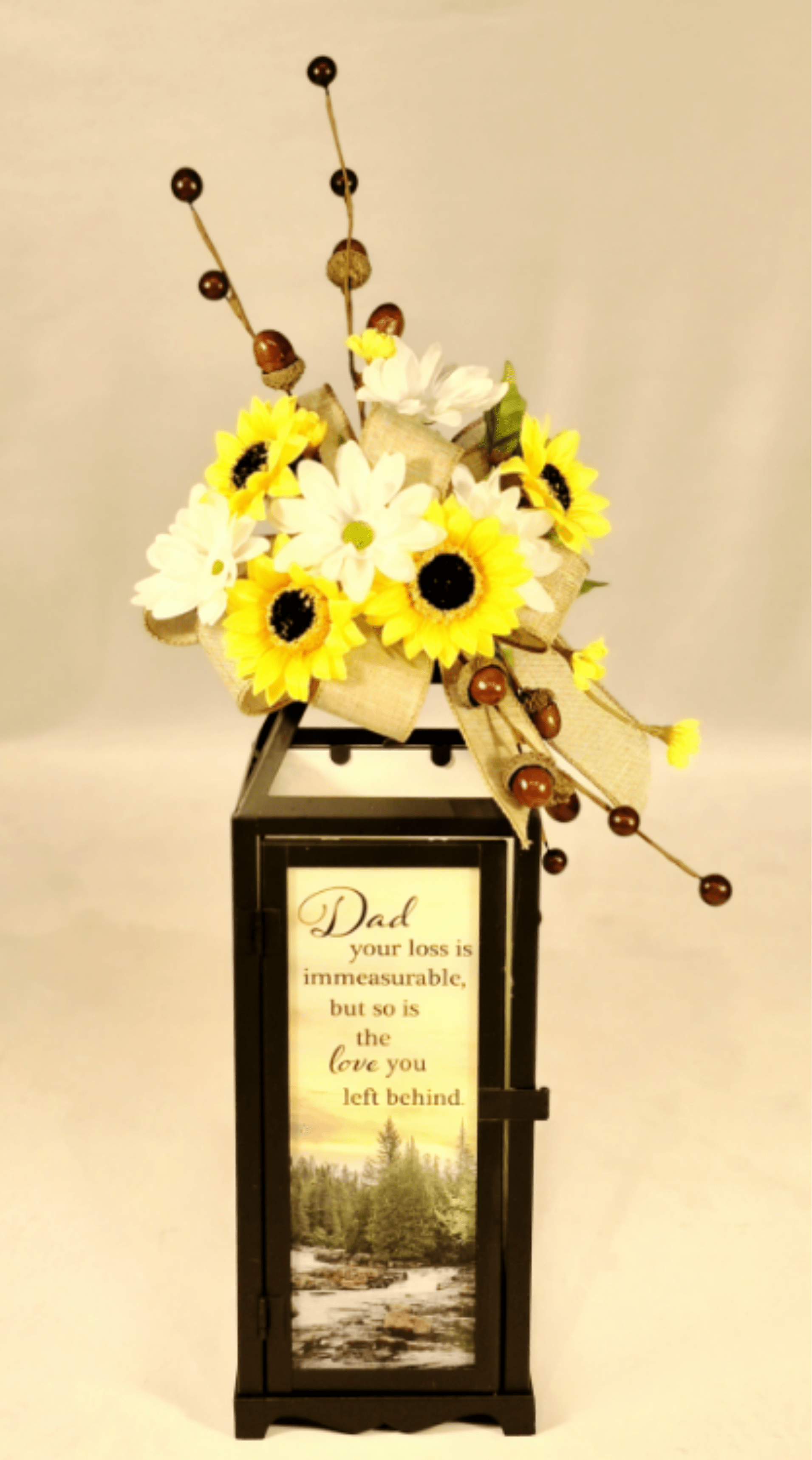 Dad Panoramic Lighted Sympathy Lantern  Dad Panoramic Lighted Sympathy Lantern  - The heartfelt sentimental message and scenic nature imagery on this lantern for the loss of a loved one. The message reads: "Dad, your loss is immeasurable, but so is the love you left behind", making a lovely remembrance piece.  This beautiful lantern measures 15.5"H x 4.75"W.   This lantern features a flameless LED candle with a beautiful flickering appearance for a warm ambience. When switched on, the light runs on an automatic timer of 6 hours on, 18 hours off. Lantern requires 3 AAA batteries included.