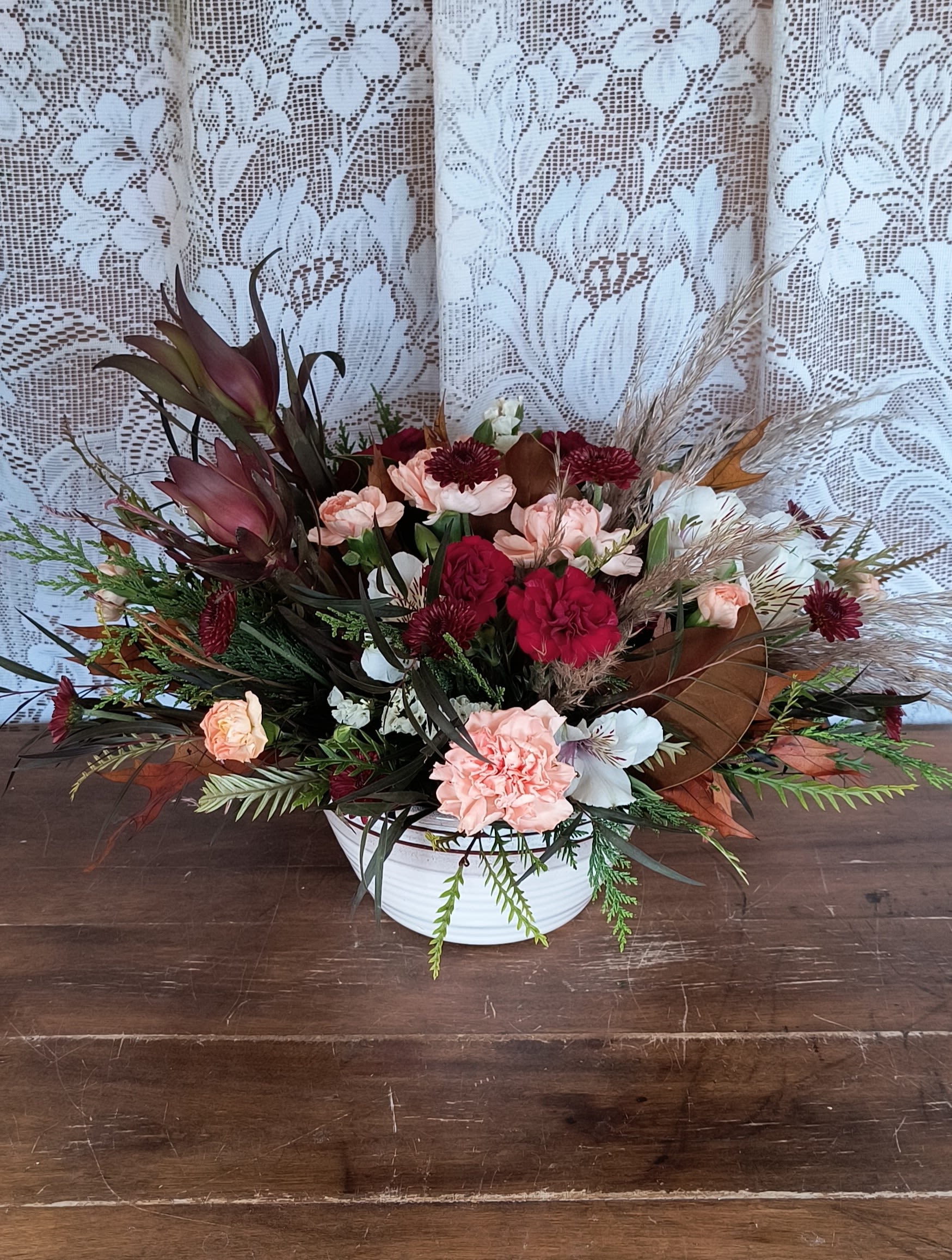 Timeless - Brighten their day with a Timeless treasured Bouquet, showcasing radiant red and cream blooms presented in a sleek ceramic bowl. It's an inspiring blend of elegance and nostalgia.