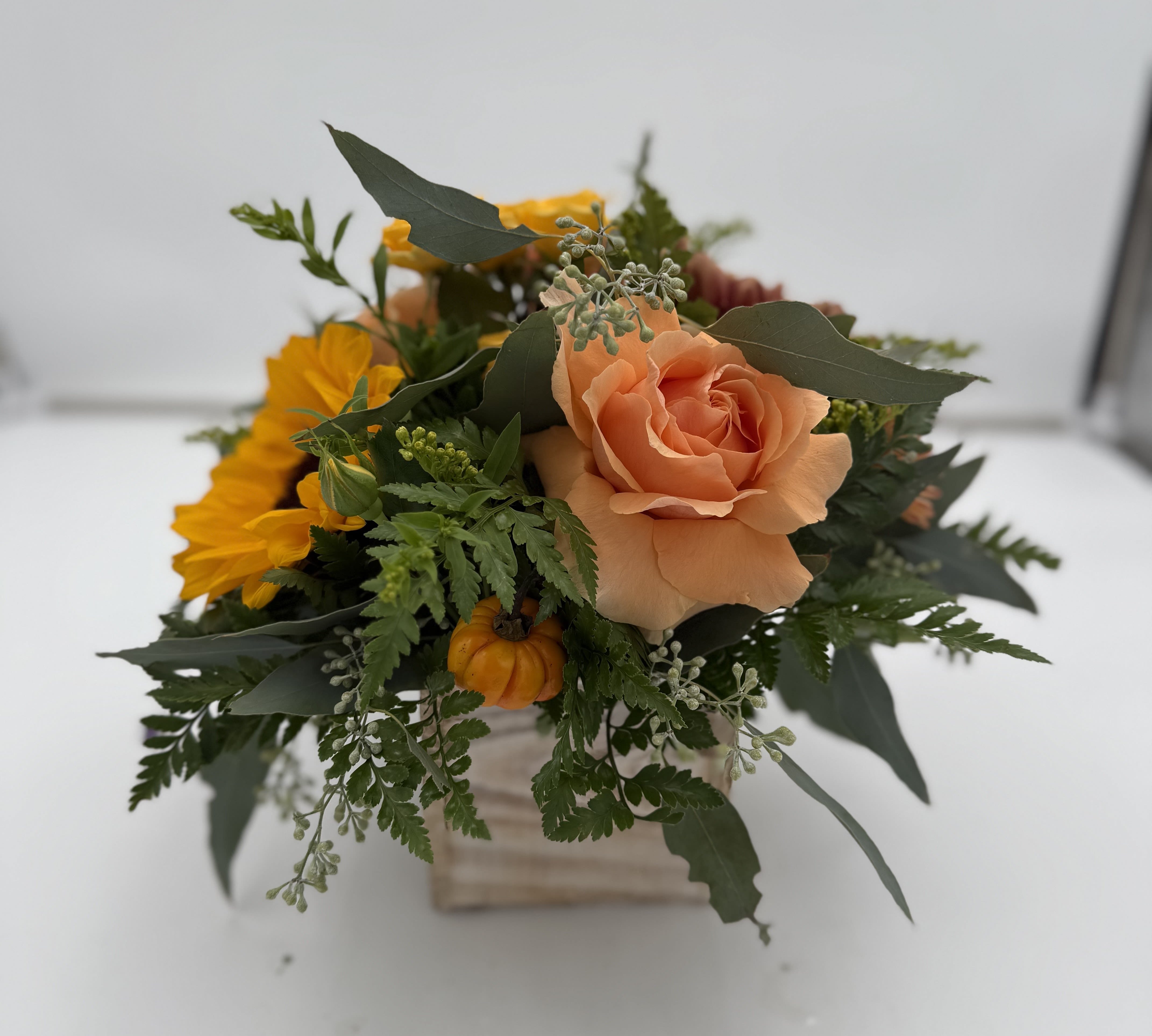 "TURKEY" "TURKEY" - "TURKEY" was created by our in house designer Caity!  It just looks like all things fall and Thanksgiving! In this arrangement you will find roses, spray roses, a sunflower, mums, berries, seeded eucalyptus in a square wees farmhouse style container.