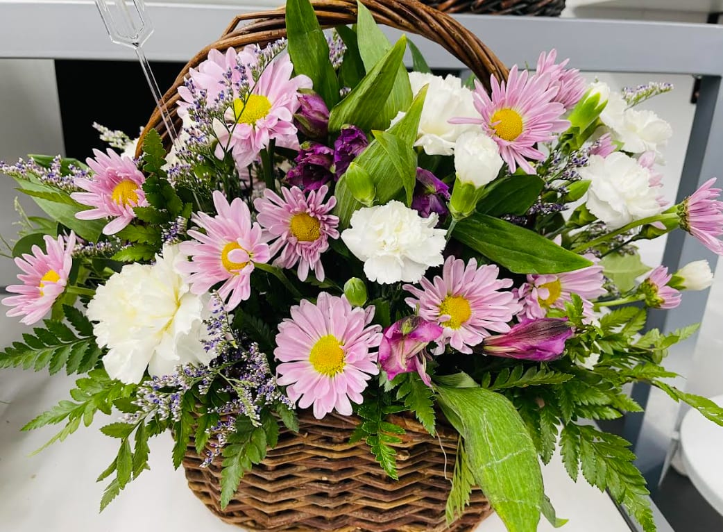 Purple Country  - Take a walk through a country meadow with this fresh flower basket! Pretty blooms of purple nestle happily inside a natural gift basket.