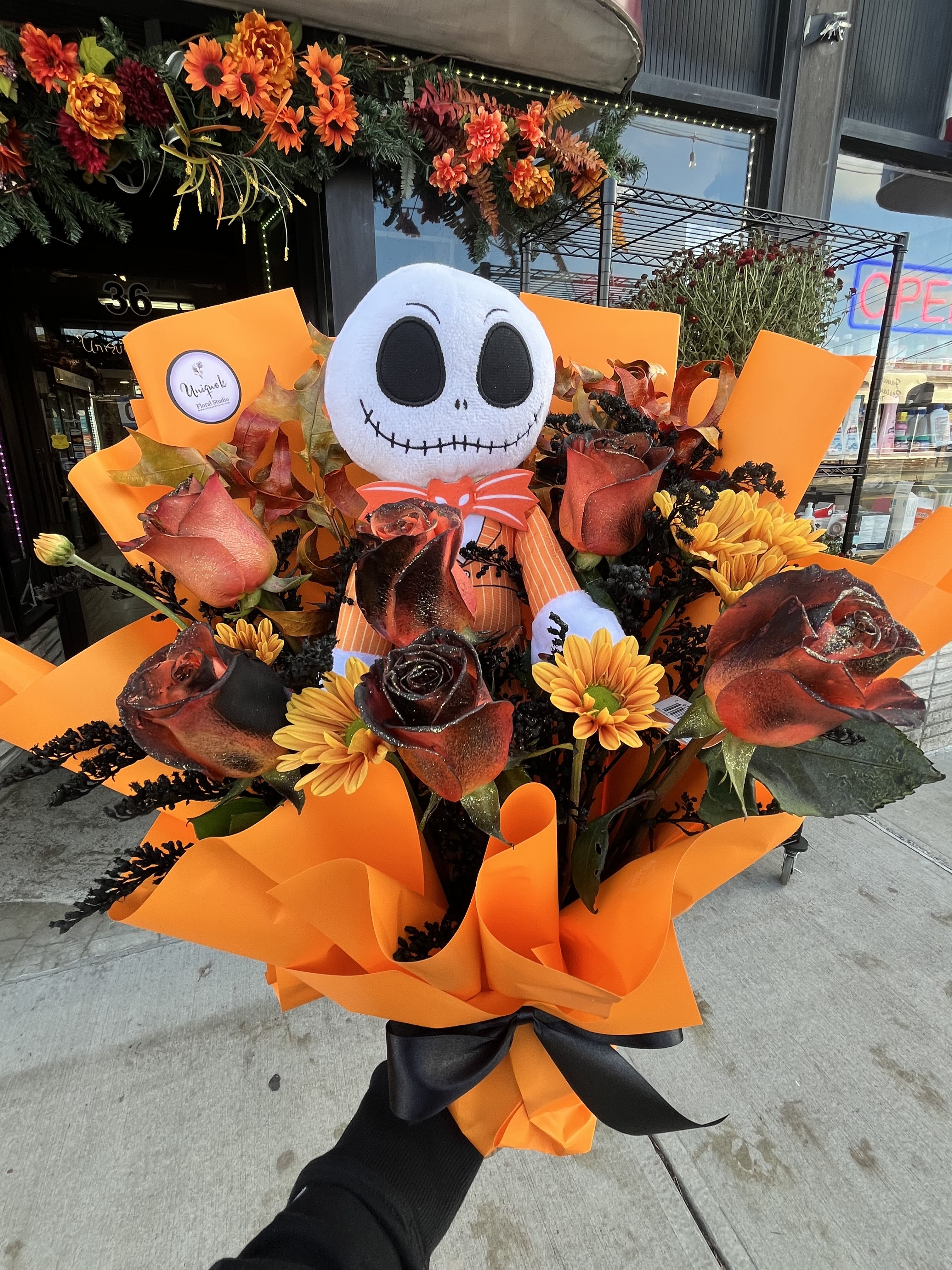 Halloween Designer Bouquets - Celebrate spooky season in style with our Halloween-themed designer bouquets — crafted fresh and made to order! Each arrangement features a mix of striking seasonal blooms like black and orange roses, chrysanthemums, and carnations, beautifully wrapped in bold Halloween colors.   Available with or without a plush character, these fun and festive bouquets make the perfect gift for any Halloween lover or themed event.   Custom designs available —made fresh at Unique K Floral Studio