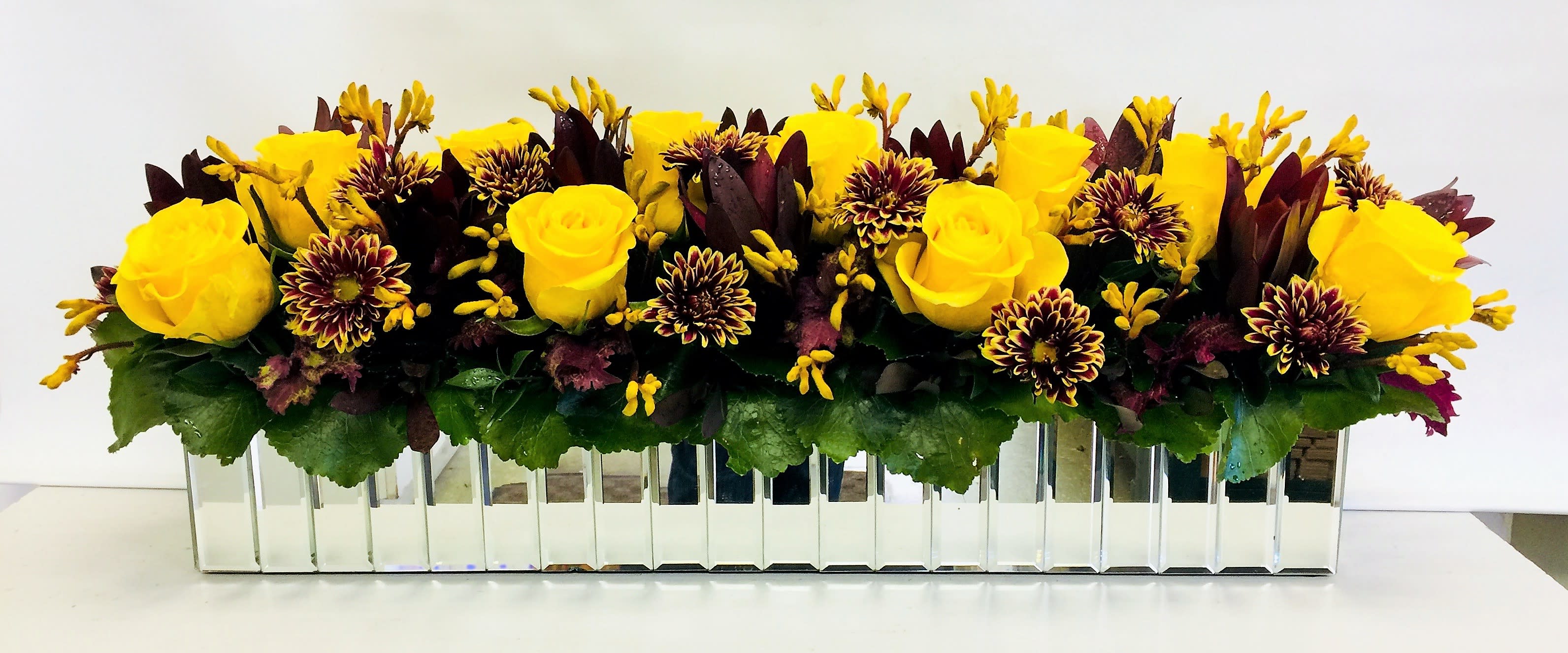 Bright Yellow Splendor - A Beautiful Assortment of Yellow Roses,  and Mums Designed in This 24 Inch Rectangular  Mirrored Container Makes This A Great Choice  For Your Dining Room Table This Fall. Some Flowers May Vary Depending on Availability. (48 Inch Rectangular Container Available. Call For Pricing.)