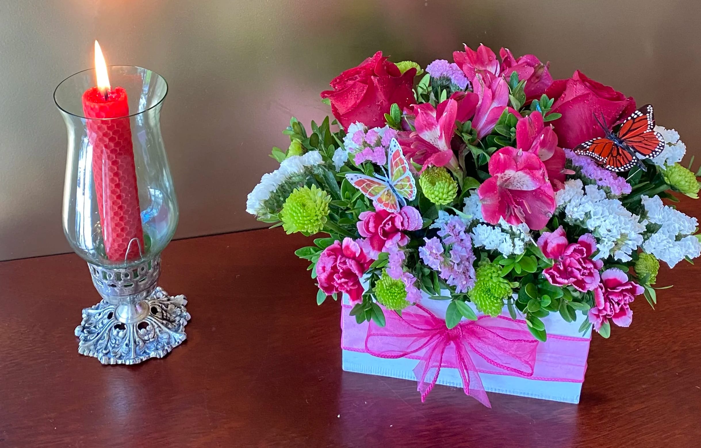 Butterfly Box - Give someone the gift of a seasonally appropriate, overflowing garden, right in their home. This bouquet is filled with bright red roses, green poms , pink alstroemeria. You can send these as a thank you, a congratulations, or simply a "I'm thinking of you!"  Delivered in a white box.