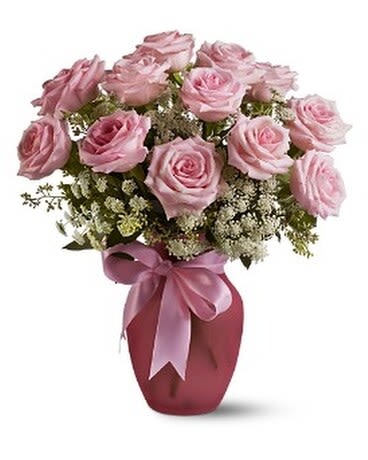 A Dozen Pink Roses and Lace - A vision of sheer loveliness, this exquisite arrangement of pink roses and Queen Anne's lace in a rose-colored vase is a gift that will be long remembered. No special occasion? Even better.