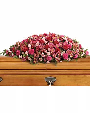 A Life Loved Casket Spray  - As a tribute to a special person who has passed, this magnificent cascade of pink floral favorites is a radiant testament of profound and lasting love.