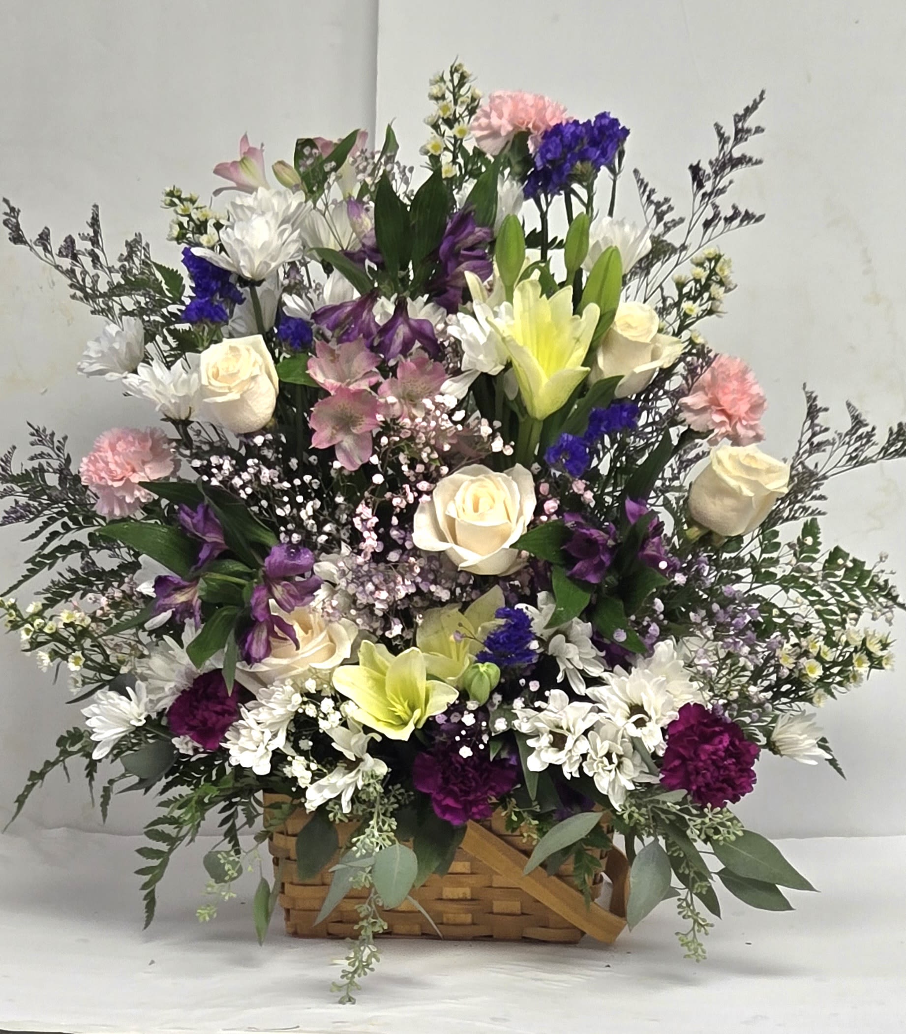 Nice n  Breezy - Soft pastels blooms in a split wood basket.