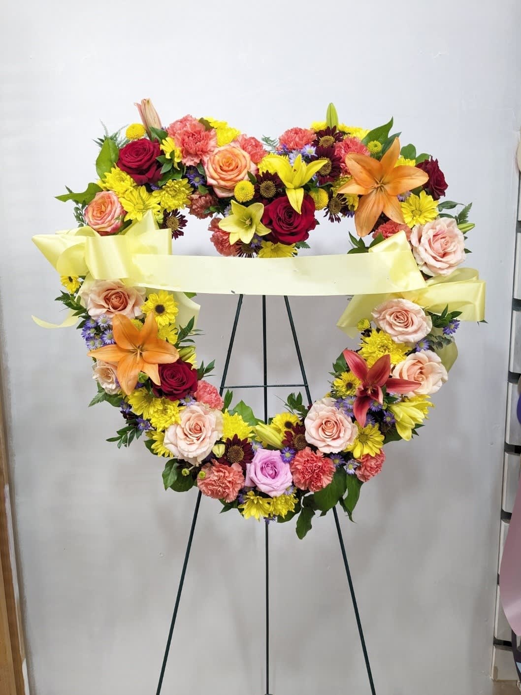 Love in our Hearts  - This heart shaped easel shows your everlasting love. Featuring a variety of colorful flowers and greenery.
