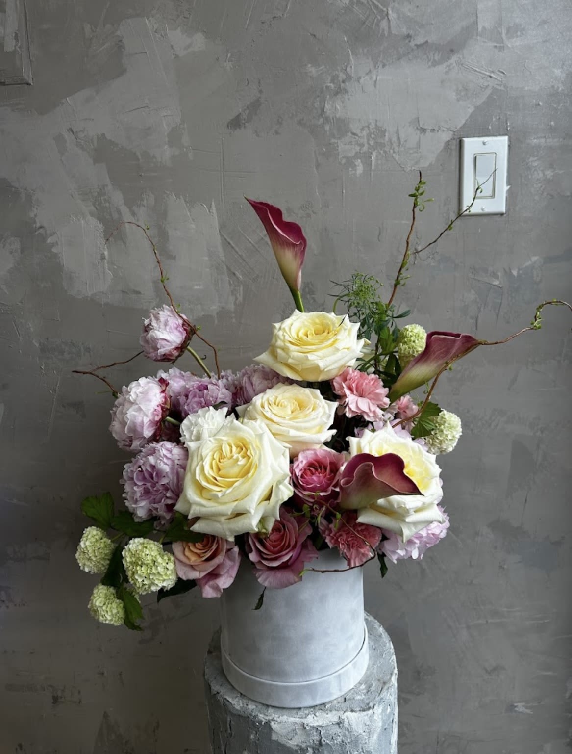 Blush Elegance  - Our Blush Elegance features a delicate mix of creamy roses, soft pink blooms, and touches of seasonal florals in a petite hatbox. Perfect for birthdays, thank you's, or &quot;just because&quot; moments when you want to share a touch of beauty. 