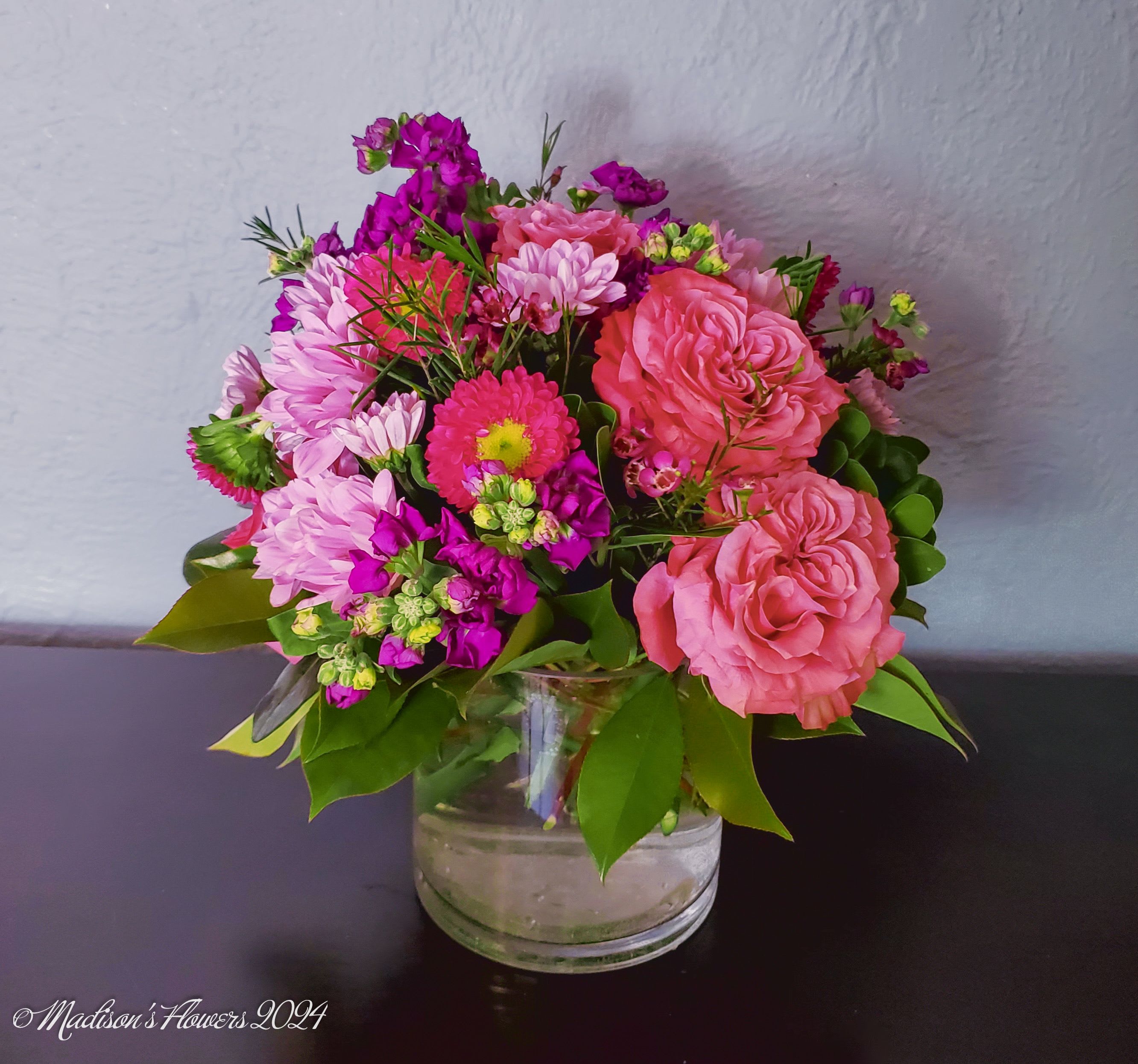 'Seeing Pink!' by Madison's Flowers - Perfect for those who love vibrancy or just simply, the color pink! Our designers will choose complementary shades of pink and stylishly arrange them into a sensibly sized, classic-round, table-top arrangement suitable for your decor.  Please let us know if there is a particular flower you would like to include, and we will do our best to accommodate if it is available and in season. 