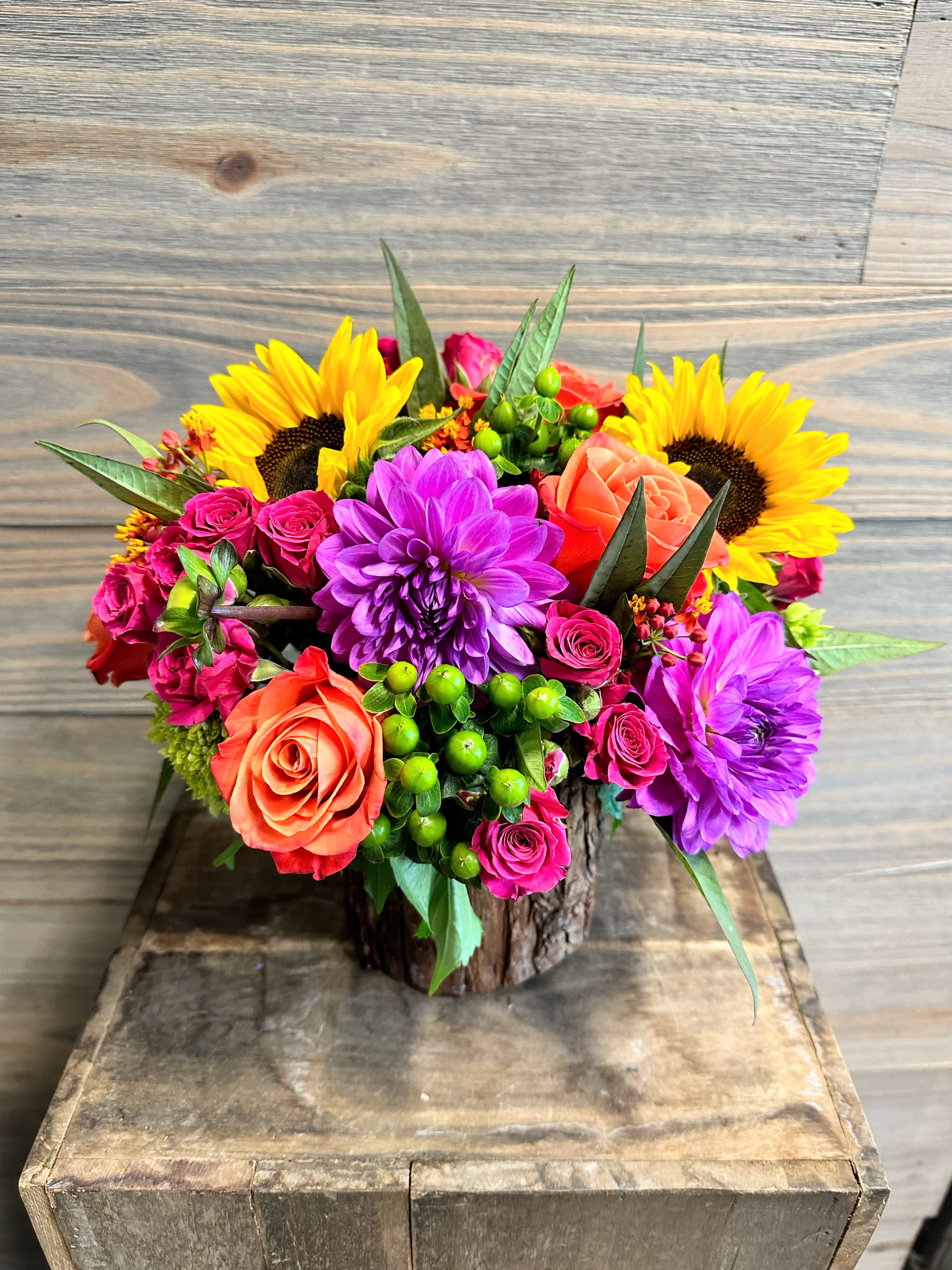 Oak Blooms Oak Blooms - A colorful bouquet of fall flowers in a specialty bark wood container.