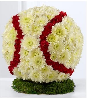 The FTD All-American Tribute Baseball - The FTD® All-American Tribute™ Baseball is a lovely way to commemorate the life of your loved one. White chrysanthemums and red mini carnations form the shape and likeness of a baseball standing on a piece of lush green moss, to create a wonderful way to remember the deceased and their favorite pastime at their memorial service. Approximately 12-inches in diameter. Your purchase includes a complimentary personalized gift message.