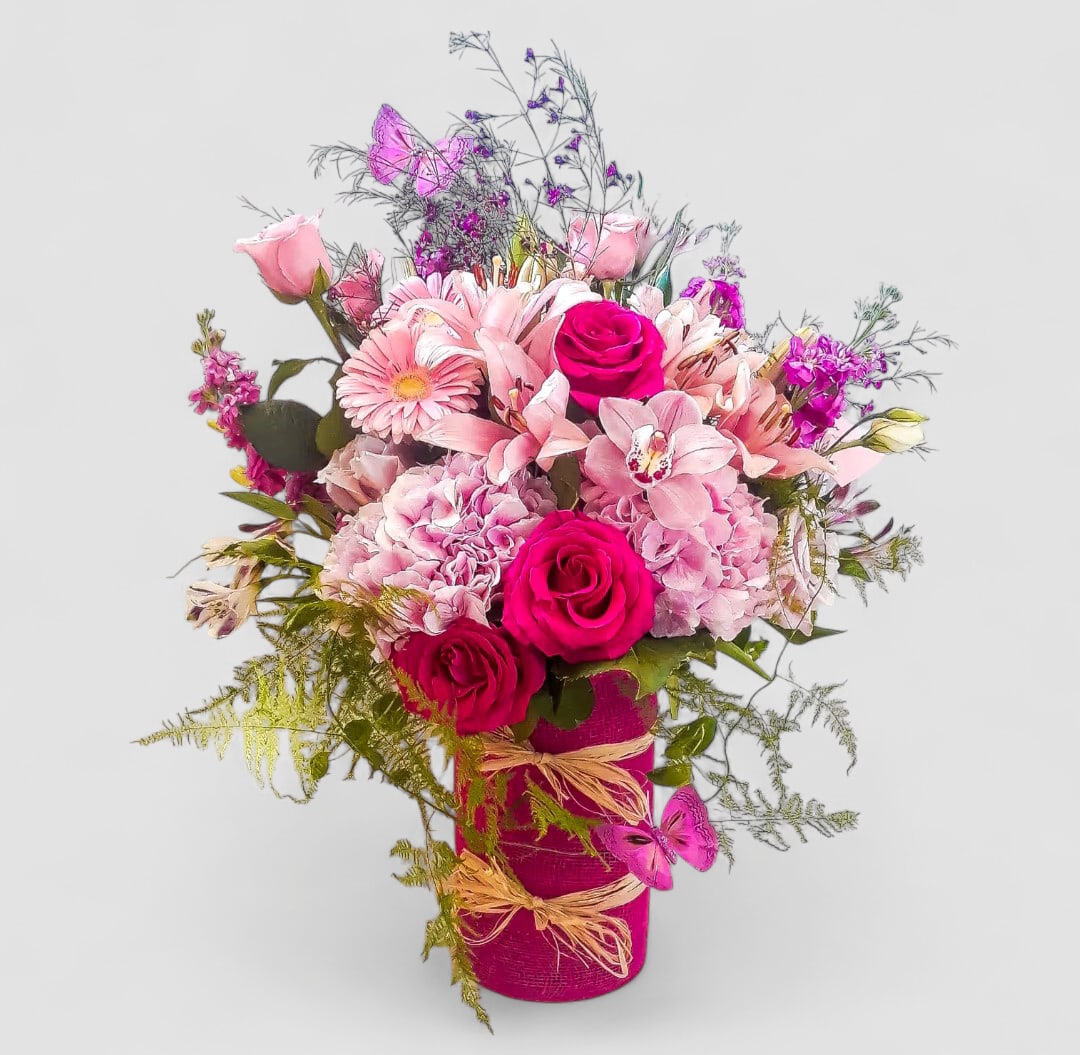 With Deepest Sympathy Bouquet Designer's Choice - Send this beautiful bouquet today to show your deepest condolences with it's lovely all pink blossoms of the day roses and so much more arranged in a tall modern glass cylinder vase wrapped in lovely pink jute ribbon. Always made extra special and unique each time. Send them happiness.