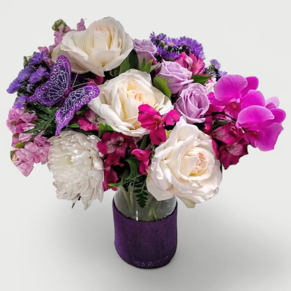 Violet Condolences Designer's Choice - Send this beautiful violet orchid bouquet today to send your deepest condolences filled with violet orchids white roses hydrangeas and more arranged in a tall modern glass cylinder vase wrapped in pretty violet jute ribbon. Always made extra special and unique each time. 